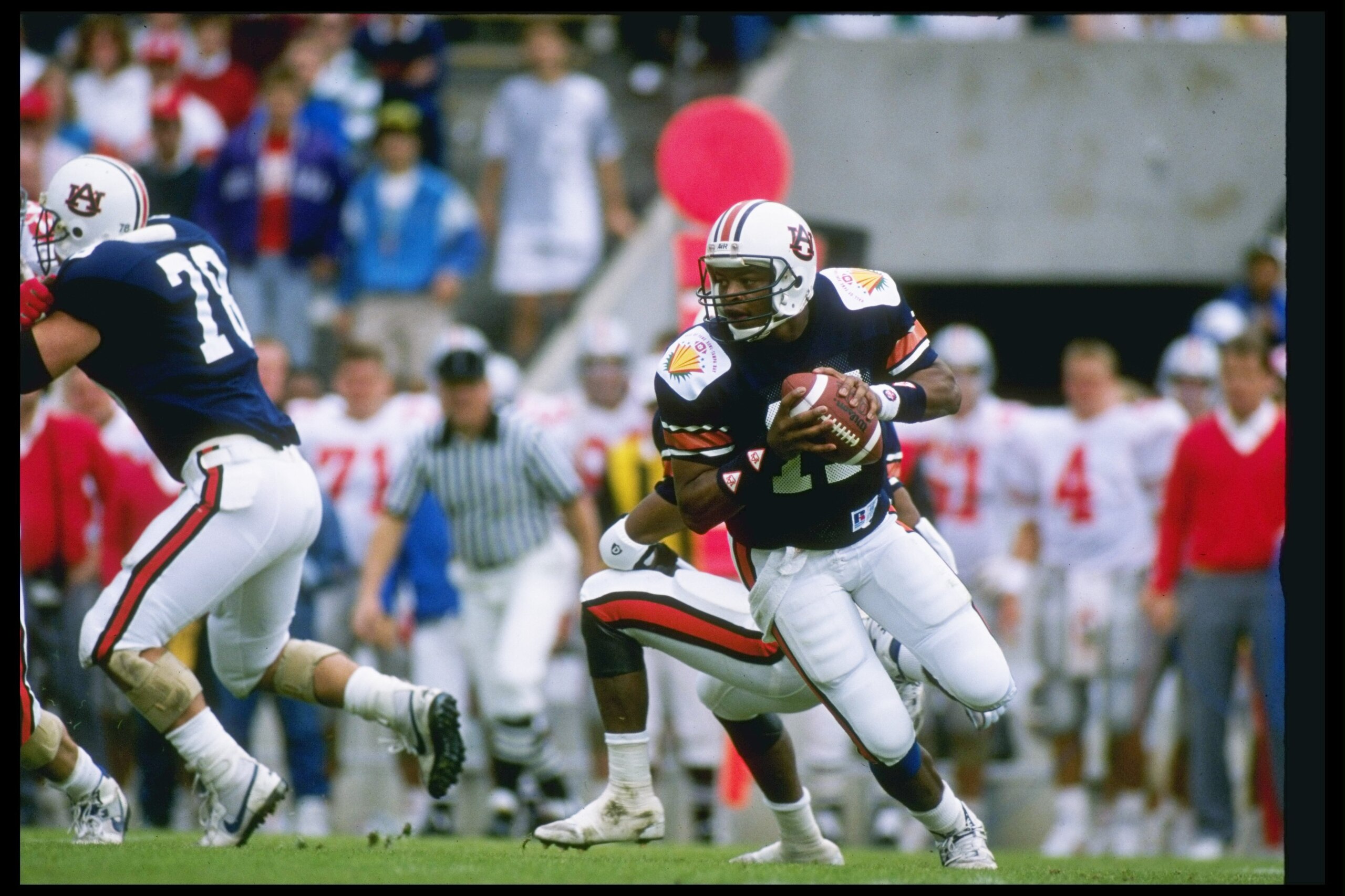 1990: Quarterback Reggie Slack of the Auburn Tigers rolls out of the pocket during a game against the Ohio State Buckeyes at the Hall of Fame Bowl in Florida. Auburn won the game 31-14. Mandatory Credit: Scott Halleran /Allsport 1990: Quarterback Reggie Slack of the Auburn Tigers rolls out of the pocket during a game against the Ohio State Buckeyes at the Hall of Fame Bowl in Florida. Auburn won the game 31-14. Mandatory Credit: Scott Halleran /Allsport