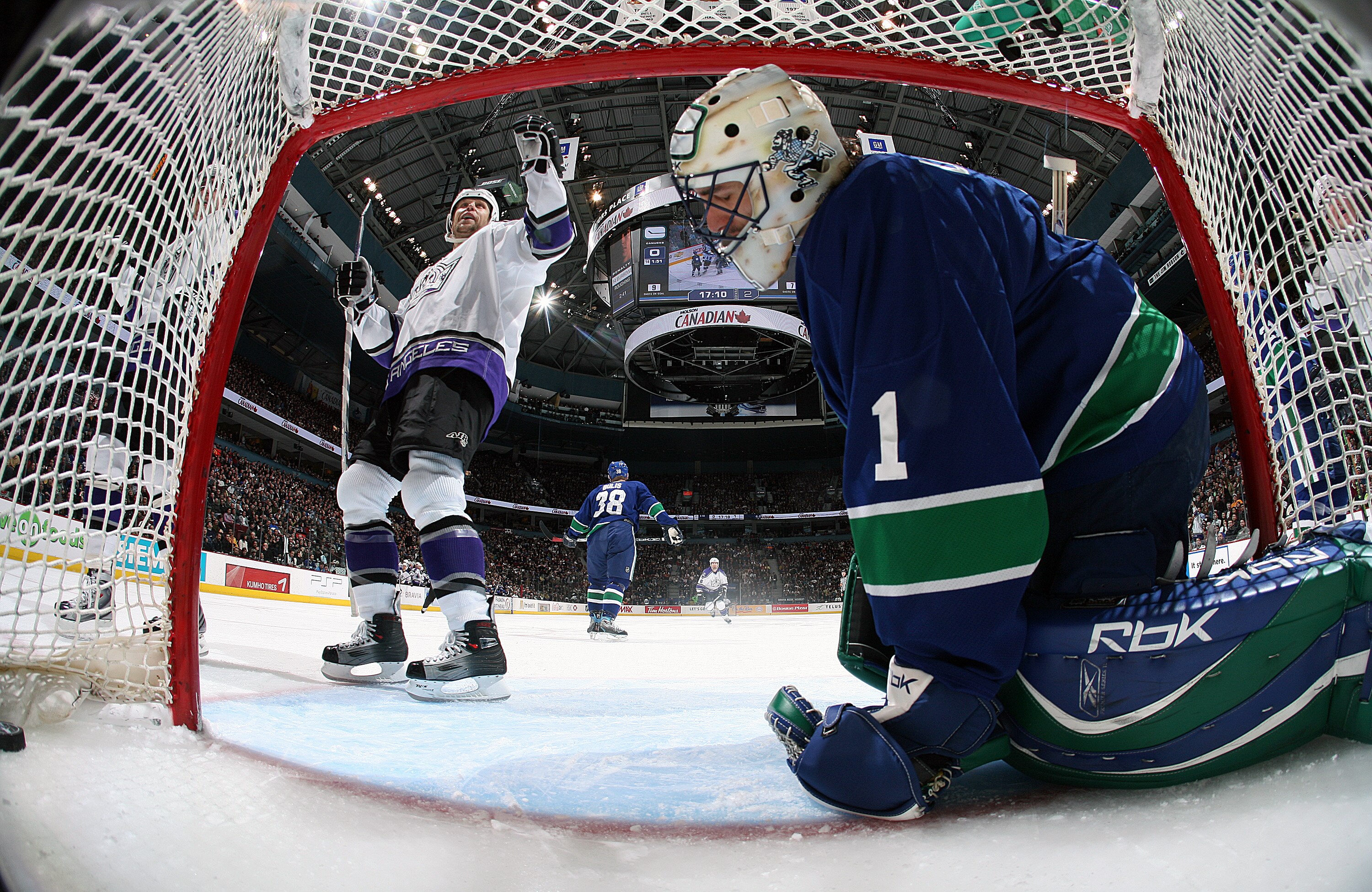 VANCOUVER, CANADA - APRIL 3:  Roberto Luongo #1 of the Vancouver Canucks sits dejected in the crease as Jaroslav Modry #44 of the Los Angeles Kings celebrates a Los Angeles goal during their NHL game at General Motors Place on April 3, 2007 in Vancouver,