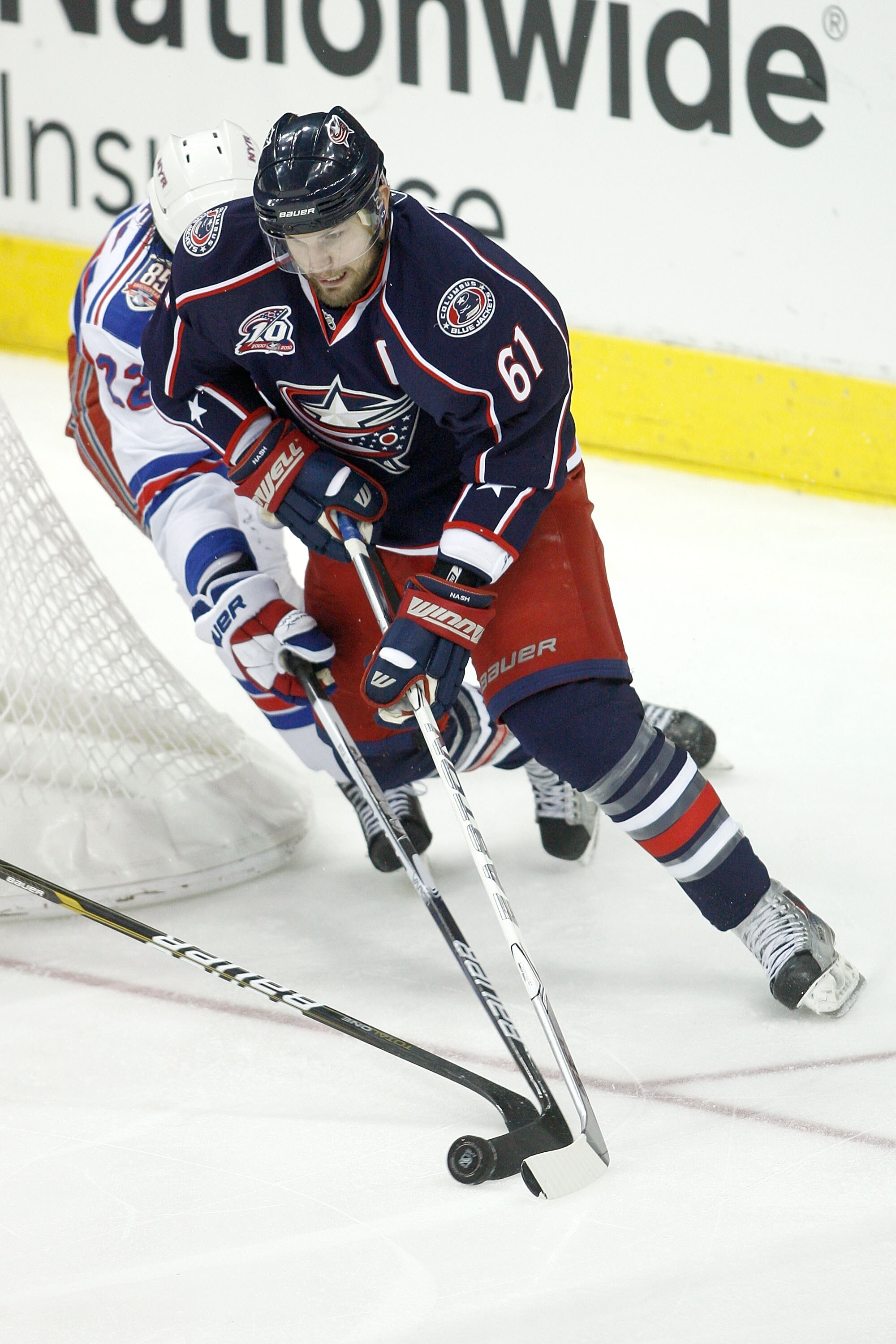 COLUMBUS,OH - DECEMBER 11:  Brian Boyle #22 of the New York Rangers chases Rick Nash #61 of the Columbus Blue Jackets around the net during the third period on December 11, 2010 at Nationwide Arena in Columbus, Ohio.  Columbus defeated New York 3-1.  (Pho
