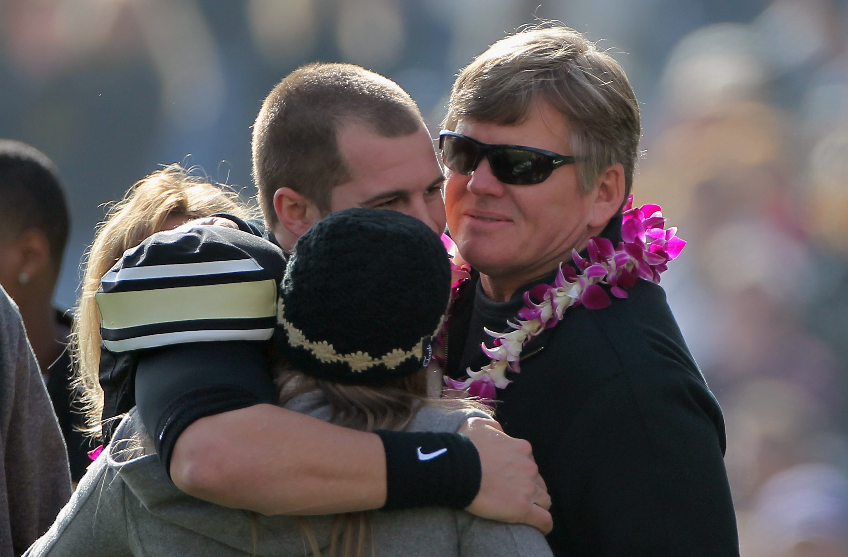 BOULDER, CO - NOVEMBER 20:  Quarterback Cody Hawkins #7 of the Colorado Buffaloes is welcomed to the field by family members including his father Dan Hawkins (R) on senior day prior to facing the Kansas State Wildcats at Folsom Field on November 20, 2010