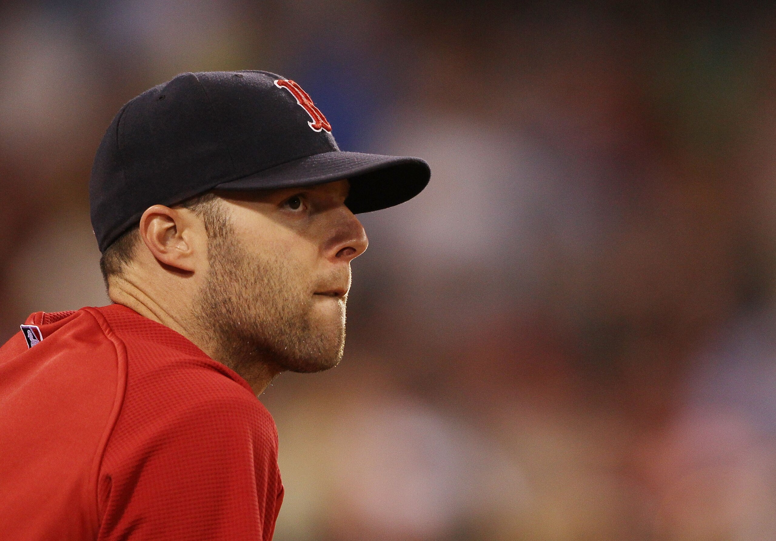 BOSTON - JULY 15:  Dustin Pedroia #15 of the Boston Red Sox watches the game from the dugout in the ninth inning against the Texas Rangers on July 15, 2010 at Fenway Park in Boston, Massachusetts. The Rangers defeated the Red Sox 7-2.  (Photo by Elsa/Gett