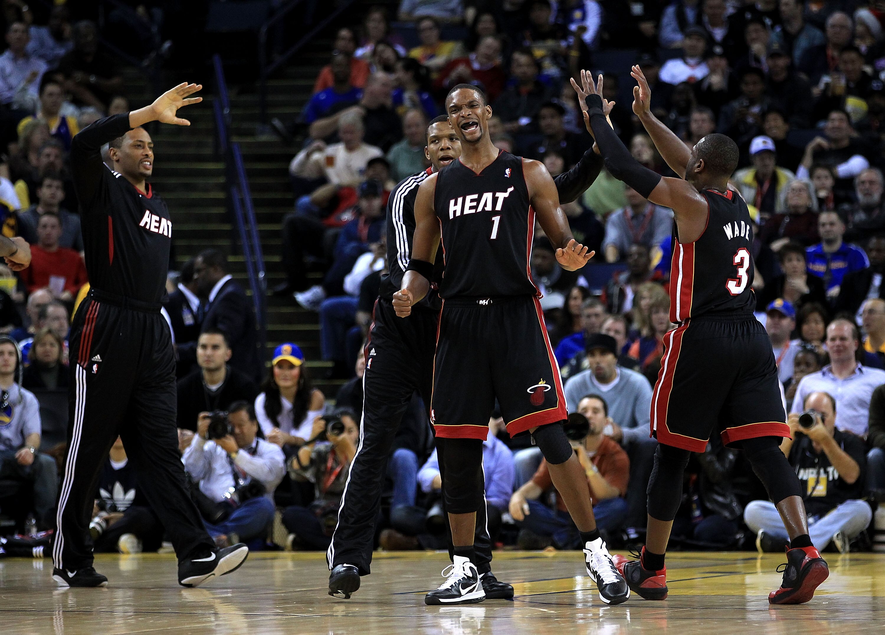 OAKLAND, CA - DECEMBER 10:  Chris Bosh #1 of the Miami Heat reacts after the Heat made a basket against the Golden State Warriors at Oracle Arena on December 10, 2010 in Oakland, California. NOTE TO USER: User expressly acknowledges and agrees that, by do