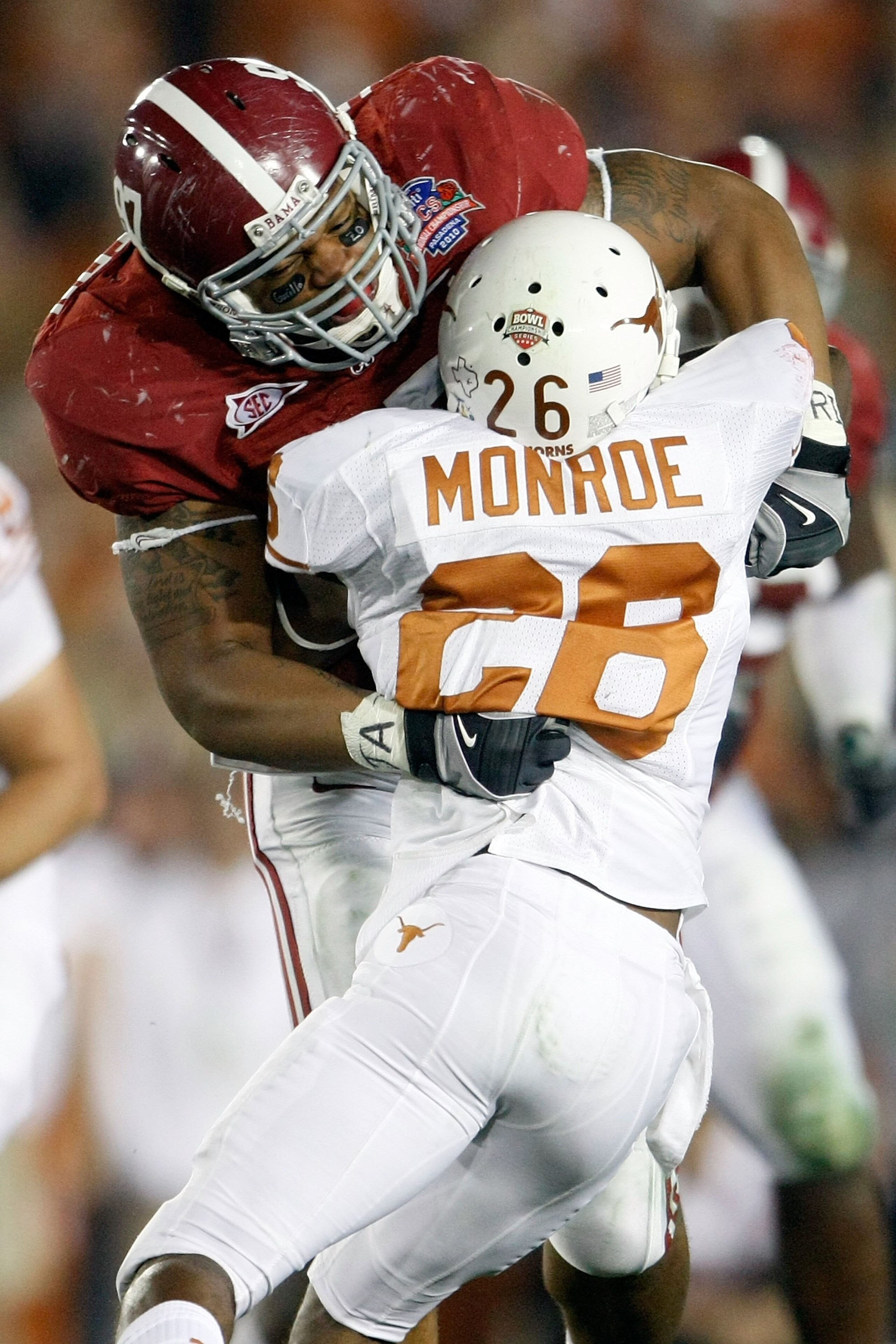 PASADENA, CA - JANUARY 07:  Lorenzo Washington #97 of the Alabama Crimson Tide tackles D.J. Monroe #26 of the Texas Longhorns during the Citi BCS National Championship game at the Rose Bowl on January 7, 2010 in Pasadena, California.  (Photo by Jeff Gross