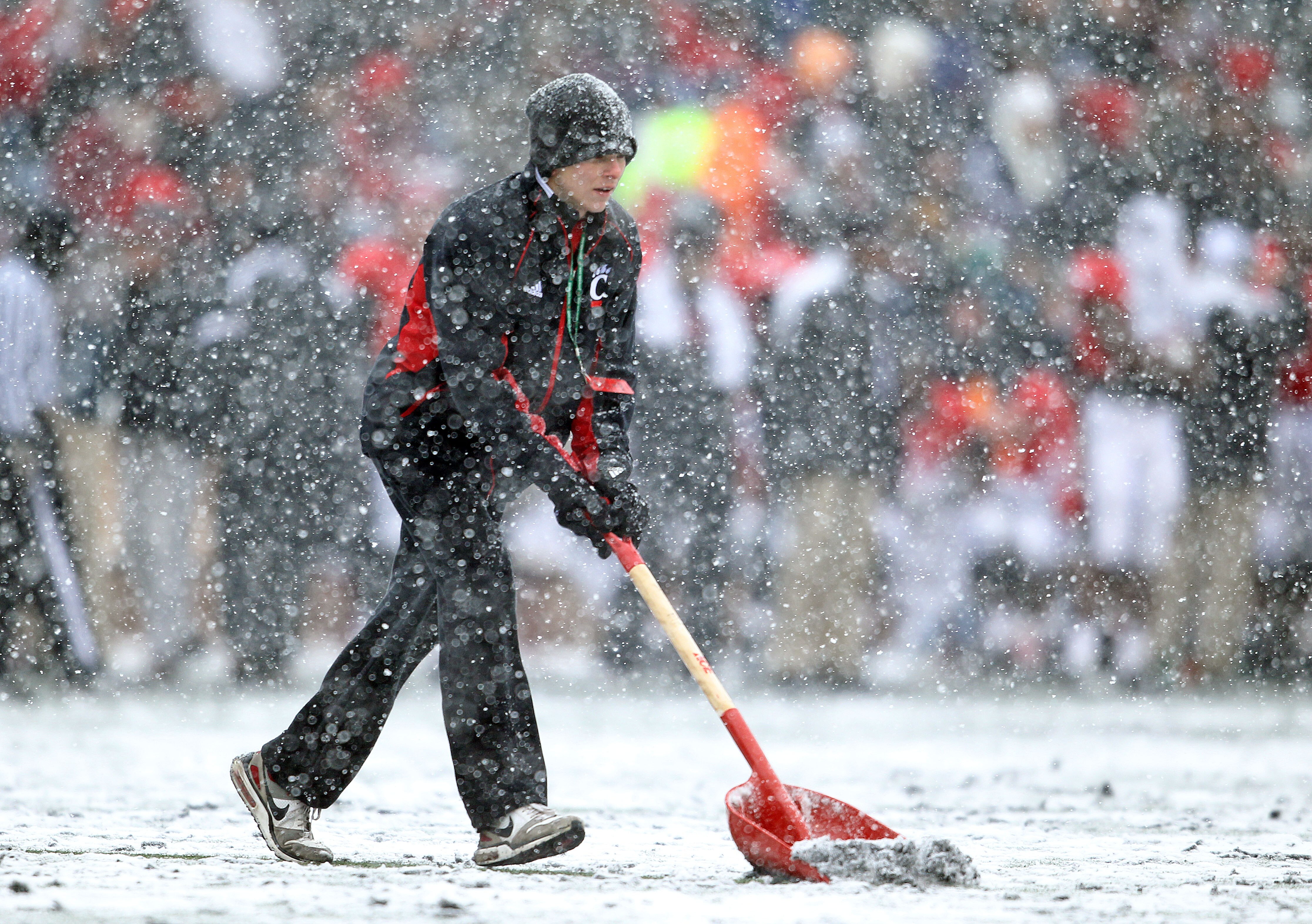 CINCINNATI, OH - DECEMBER 04:  A field worker shovels snow off of the field during the Big East Conference game between the the Pittsburgh Panthers and the Cincinnati Bearcats at Nippert Stadium on December 4, 2010 in Cincinnati, Ohio.  (Photo by Andy Lyo