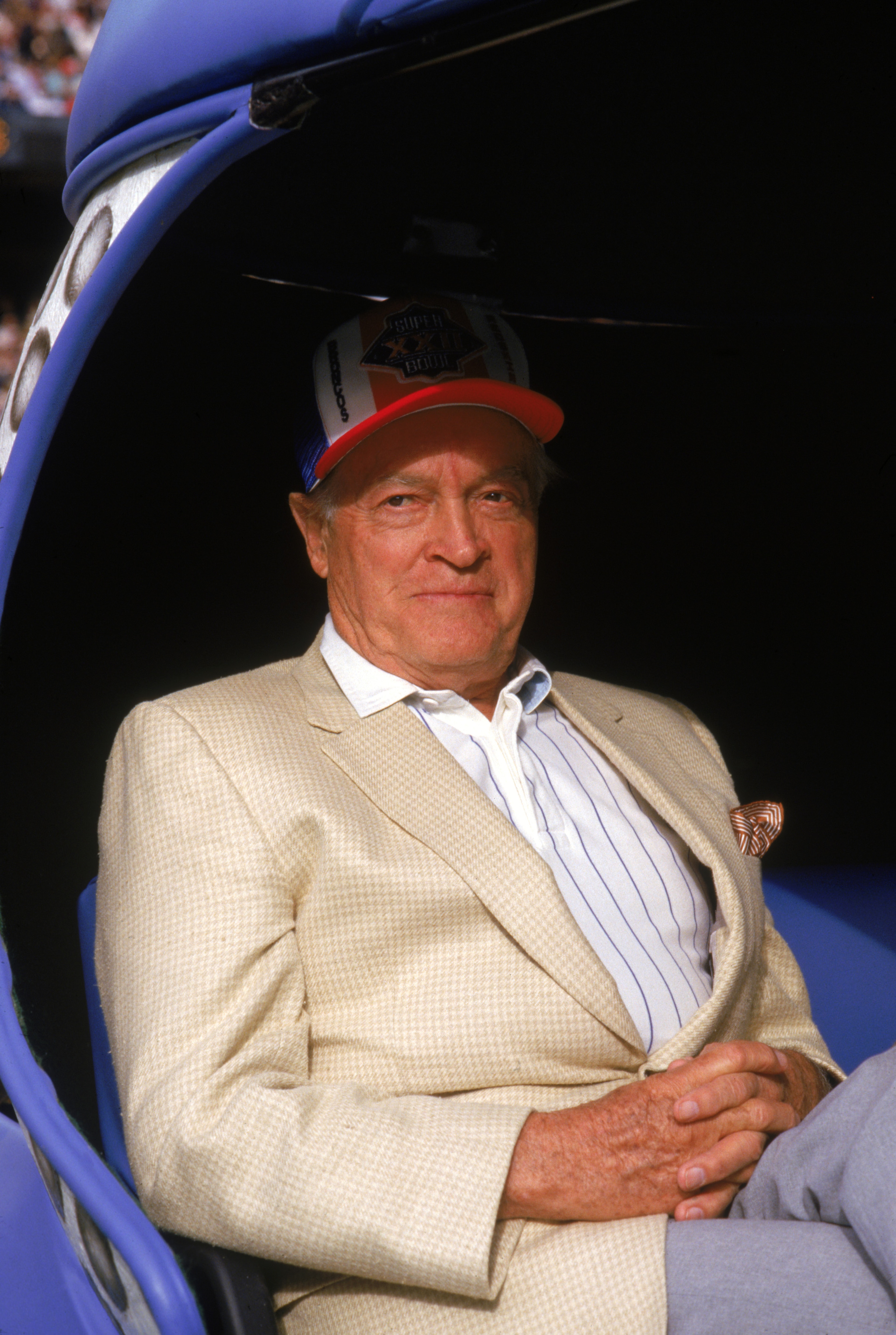SAN DIEGO - JANUARY 31:  Comedian Bob Hope sits on a cart waiting to be driven onto the field during Super Bowl XXII between the Washington Redskins and the Denver Broncos at Jack Murphy Stadium on January 31, 1988 in San Diego, California.  The Redskins