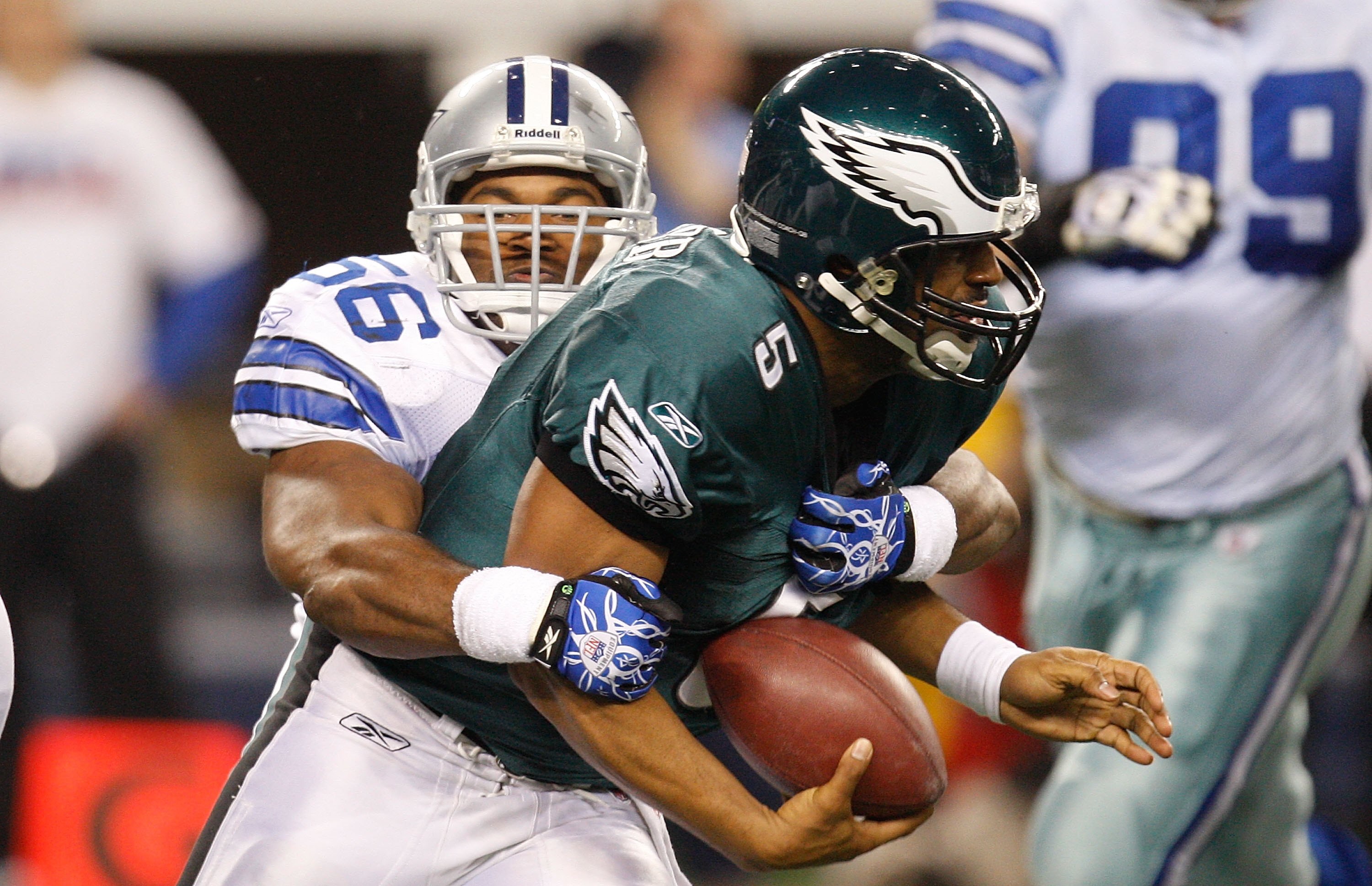 ARLINGTON, TX - JANUARY 09:  Quarterback Donovan McNabb #5 of the Philadelphia Eagles is sacked by Bradie James #56 of the Dallas Cowboys during the 2010 NFC wild-card playoff game at Cowboys Stadium on January 9, 2010 in Arlington, Texas.  (Photo by Rona