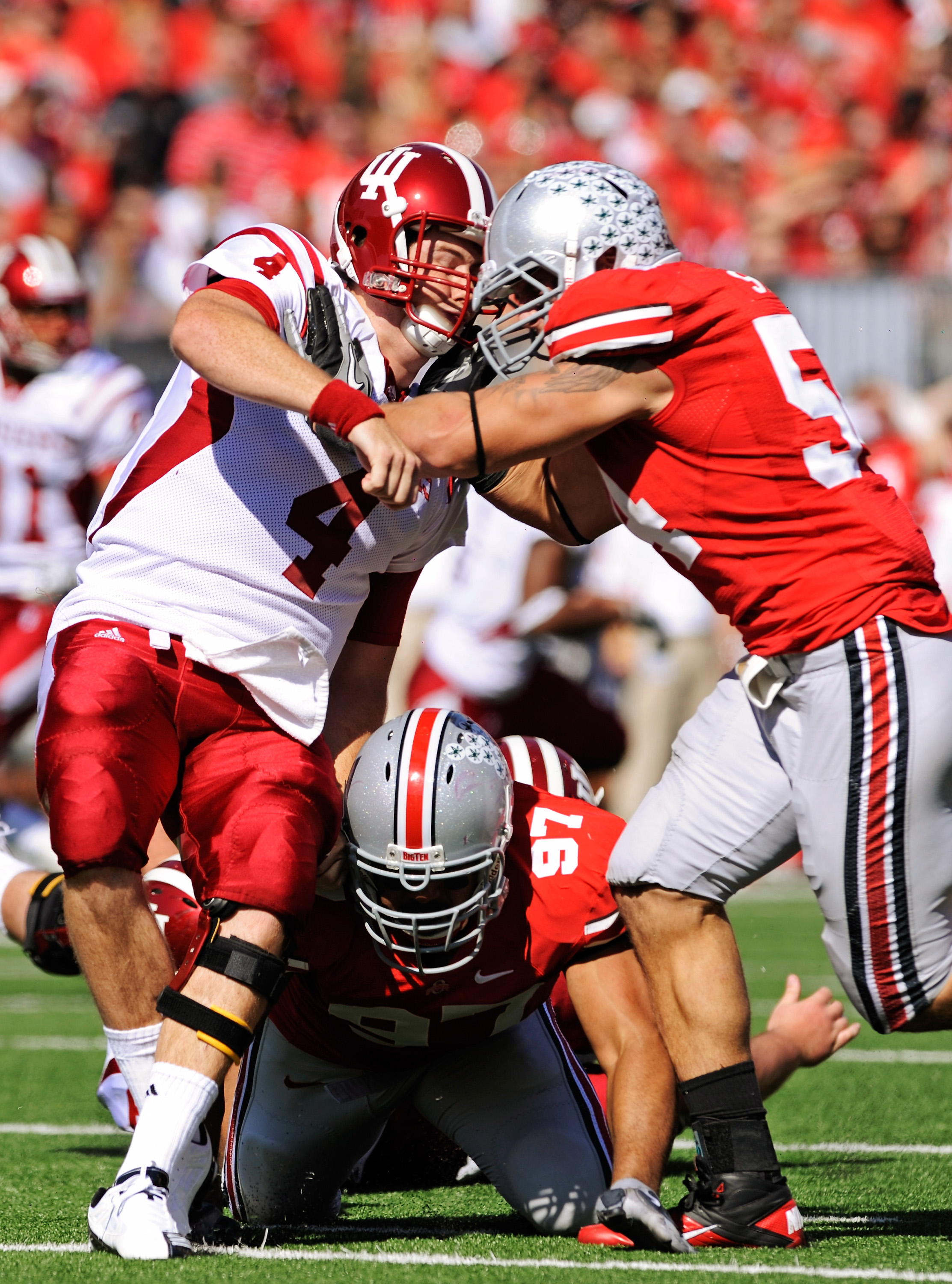 COLUMBUS, OH - OCTOBER 9:  Quarterback Ben Chappell #4 of the Indiana Hoosiers is hit just after releasing the ball by John Simon #54 and Cameron Heyward #97 of the Ohio State Buckeyes at Ohio Stadium on October 9, 2010 in Columbus, Ohio.  (Photo by Jamie