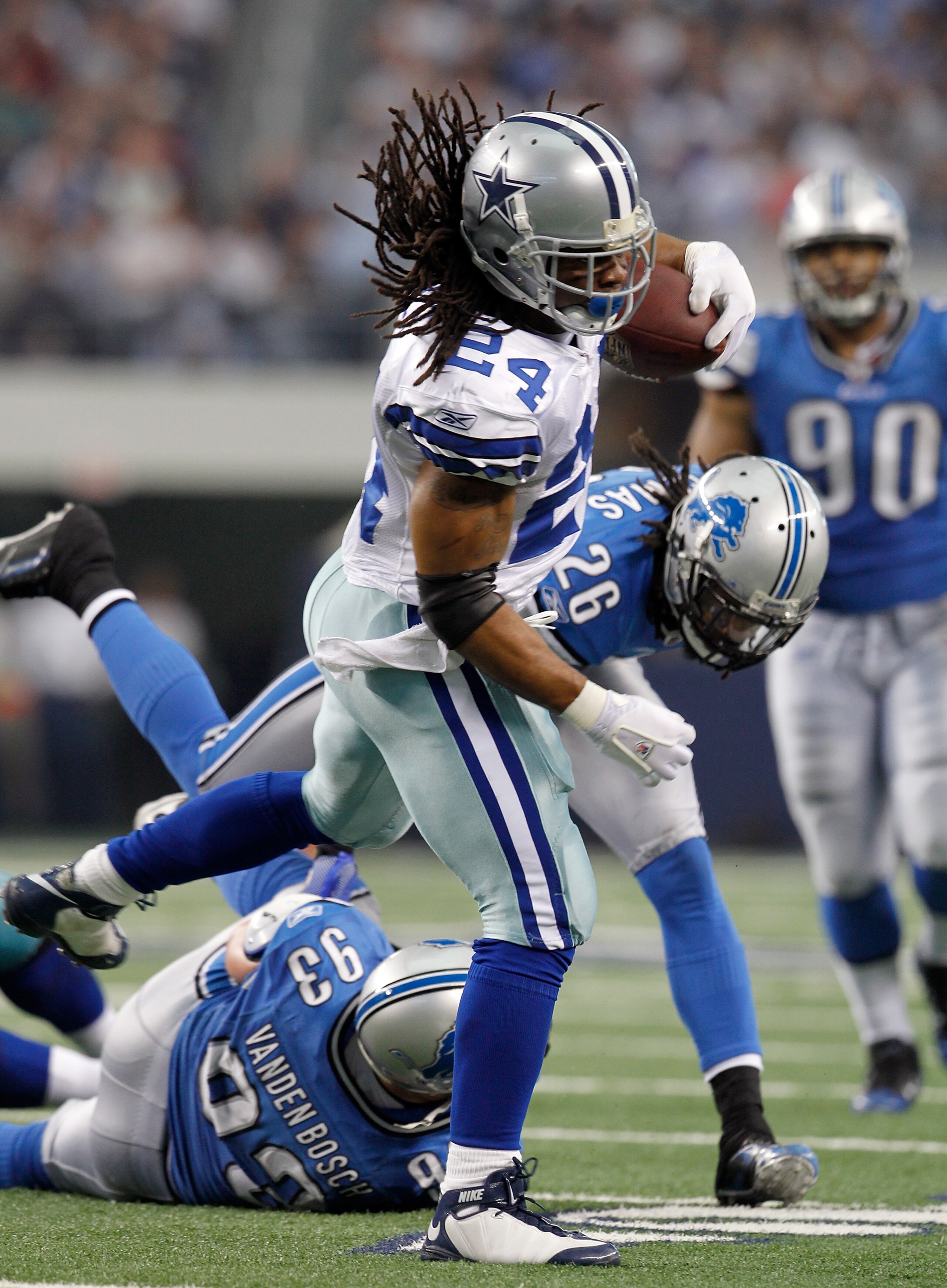 ARLINGTON, TX - NOVEMBER 21:  Running back Marion Barber #24 of the Dallas Cowboys carries the ball against safety Louis Delmas #26 of the Detroit Lions and defensive end Kyle Vanden Bosch #93 at Cowboys Stadium on November 21, 2010 in Arlington, Texas. T