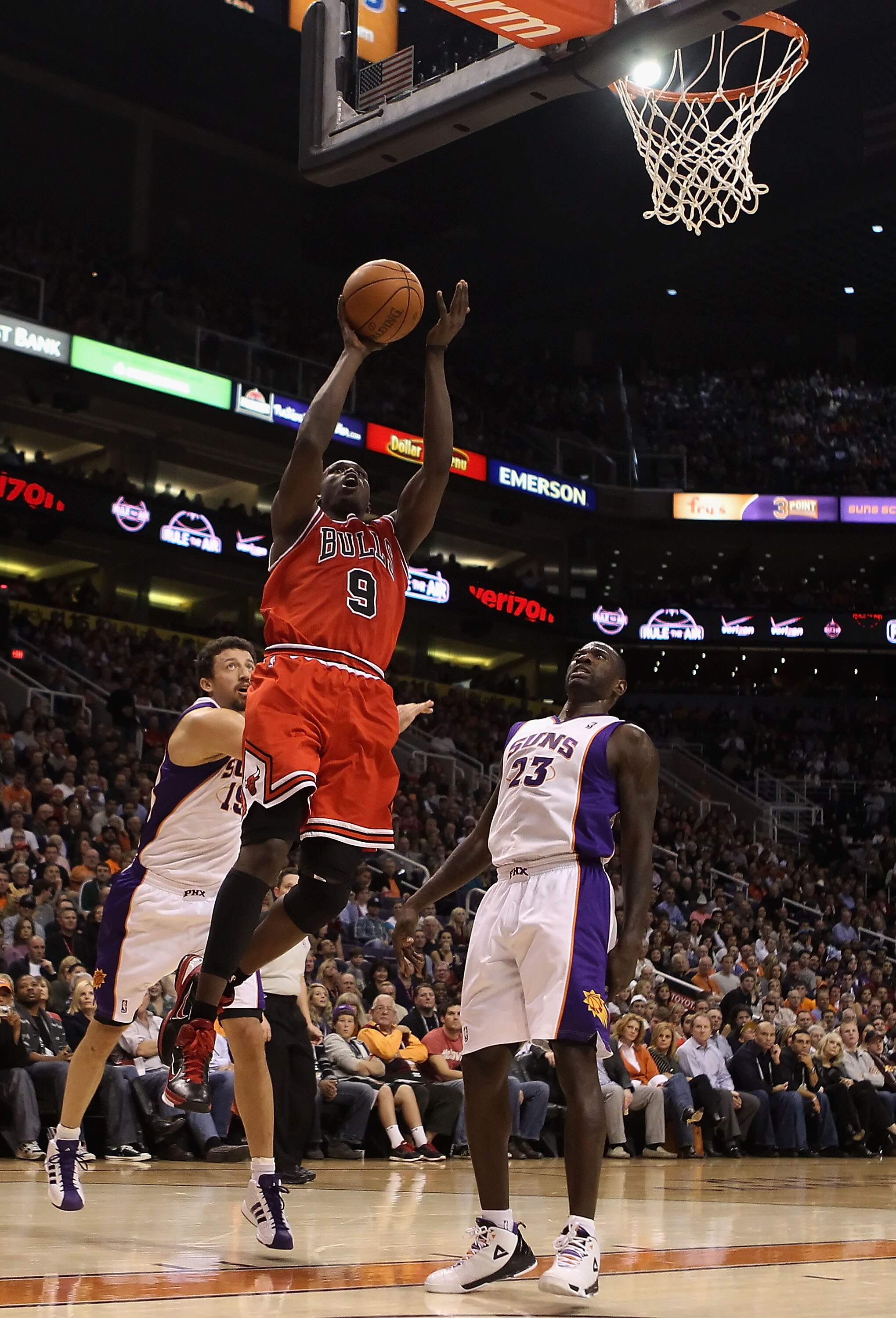PHOENIX - NOVEMBER 24:  Luol Deng #9 of the Chicago Bulls puts up a shot over Jason Richardson #23 of the Phoenix Suns during the NBA game at US Airways Center on November 24, 2010 in Phoenix, Arizona. NOTE TO USER: User expressly acknowledges and agrees