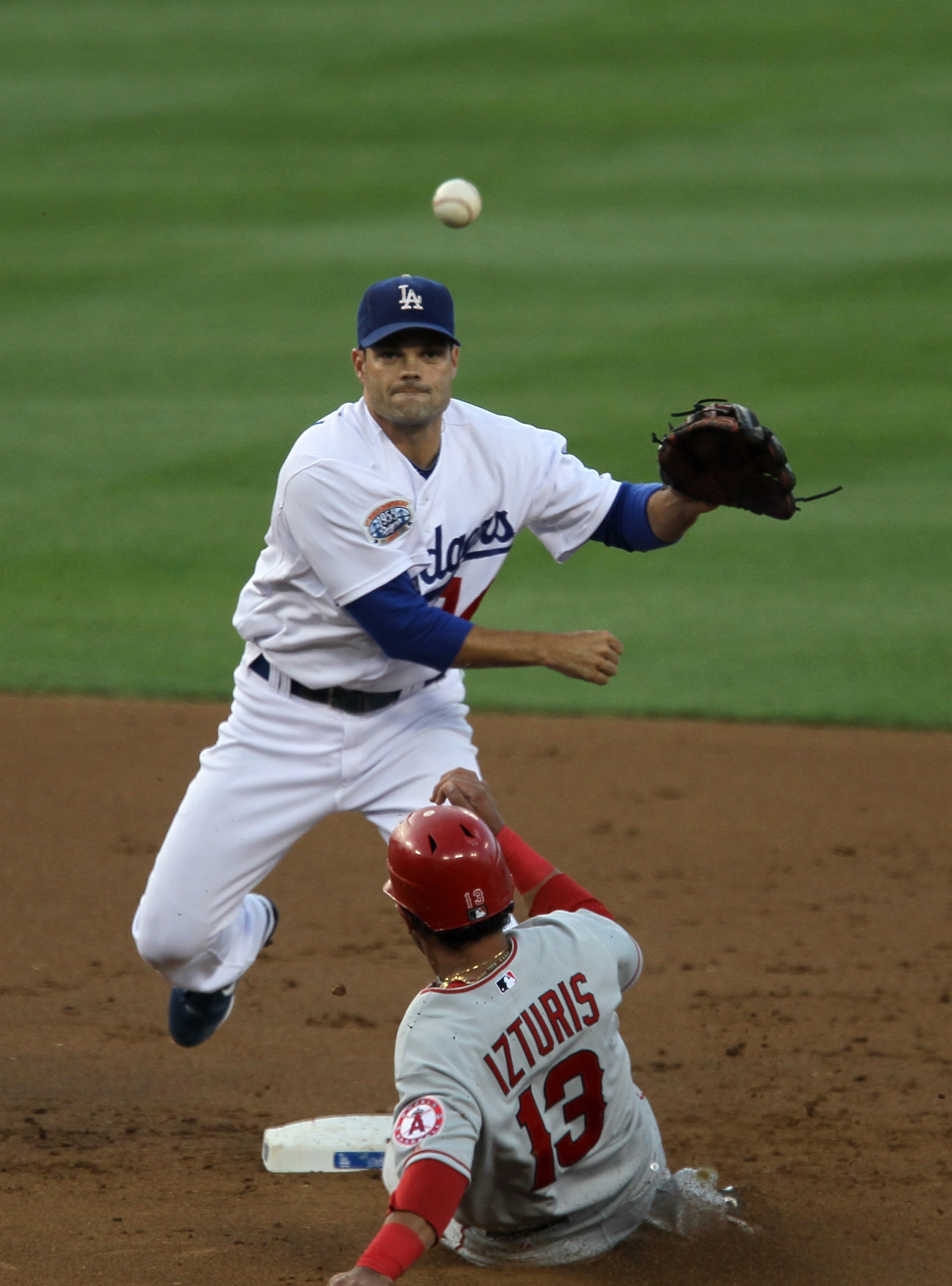 LOS ANGELES - JUNE 12:  Second baseman Jamey Carroll #14 of the Los Angeles Dodgers throws to first to complete a double play after forcing out Maicer Izturis #13 of the Los Angeles Angels of Anaheim on June 12, 2010 at Dodger Stadium in Los Angeles, Cali