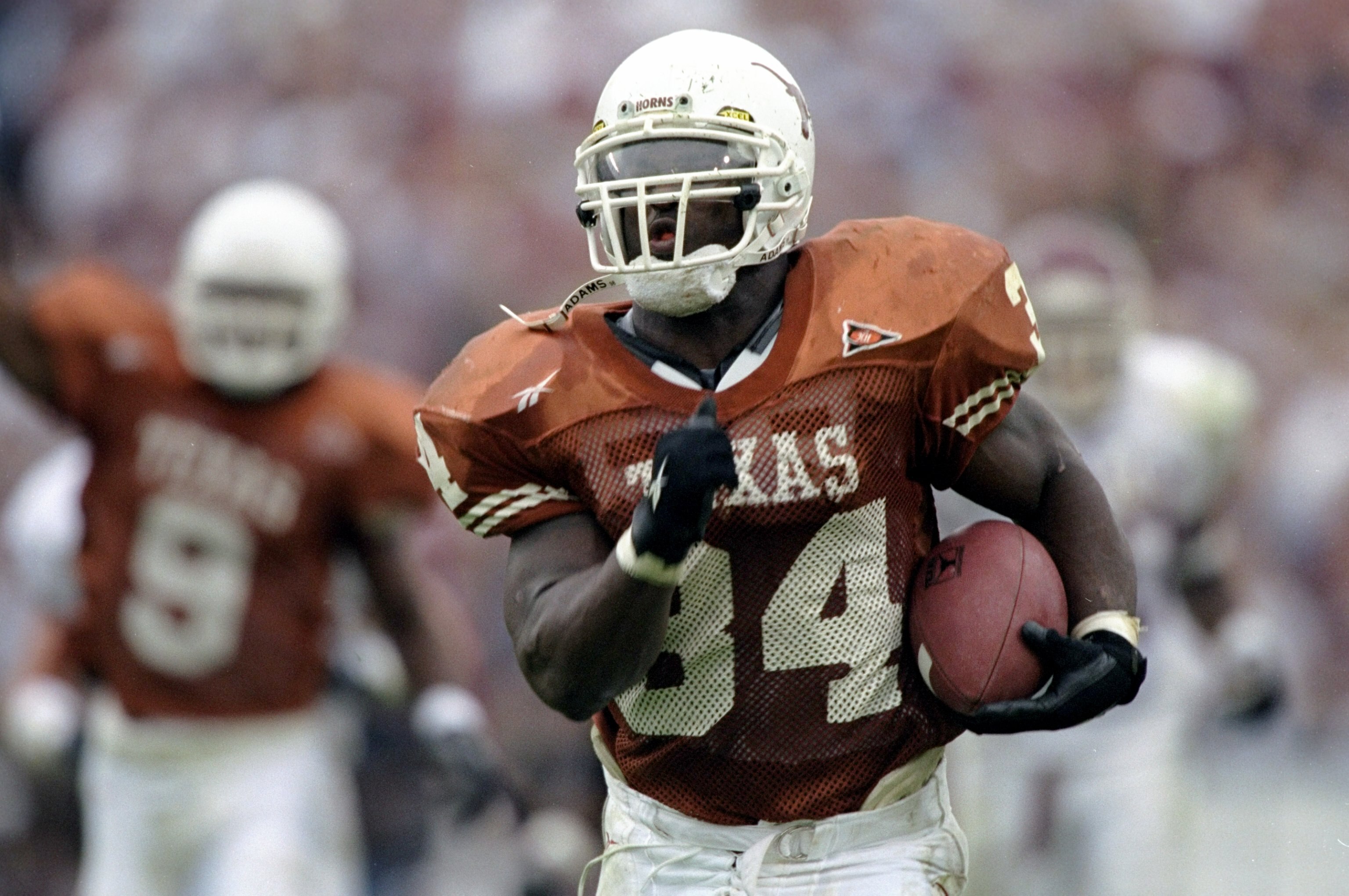 27 Nov 1998:  Tailback Ricky Williams #34 of the Texas Longhorns breaks the NCAA career yards record while running with the ball during a game against the Texas A&M Aggies at the Memorial Stadium in Austin, Texas. The Longhorns defeated the Aggies 26-24.
