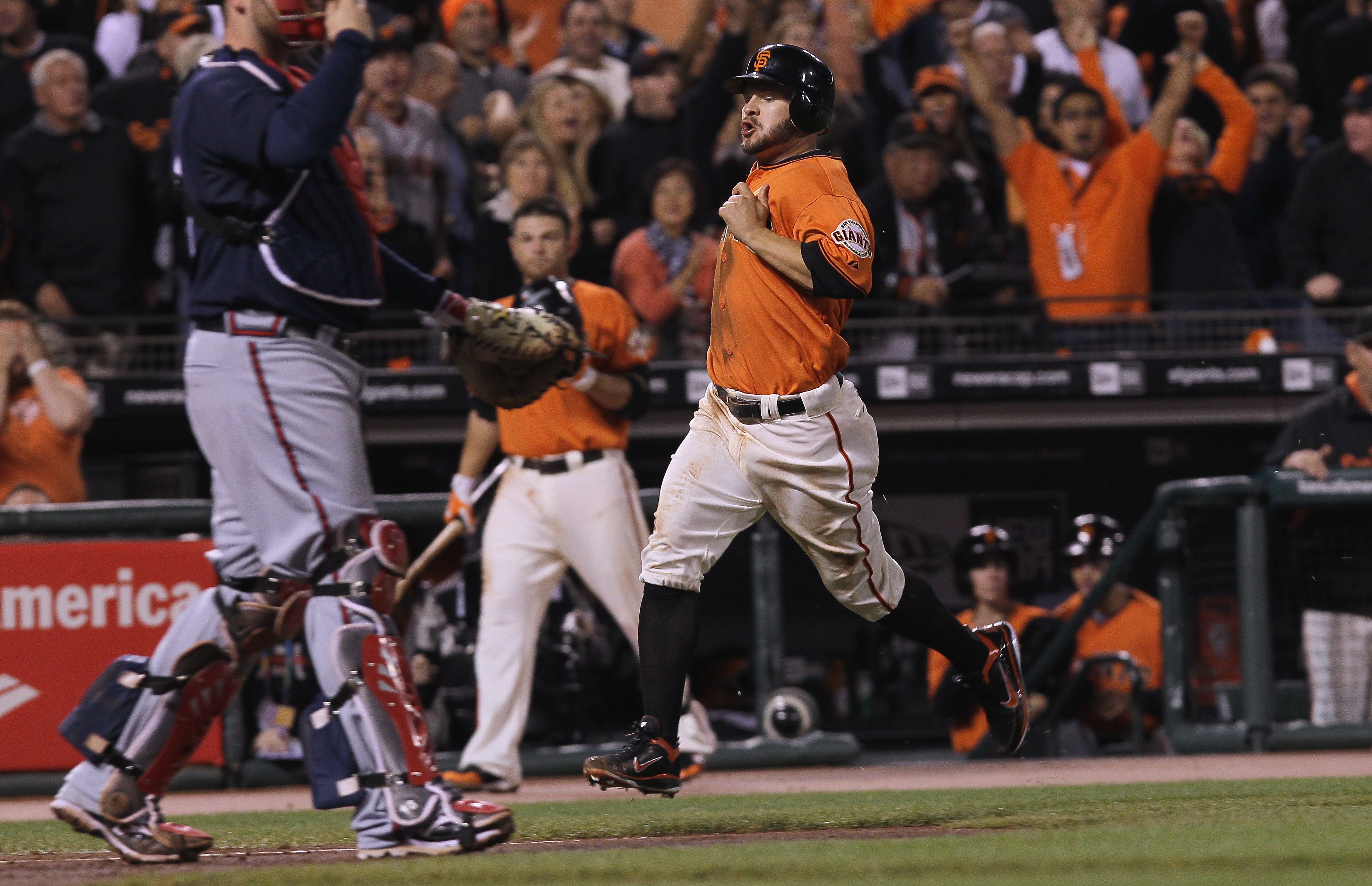 SAN FRANCISCO - OCTOBER 08:  Cody Ross #13 of the San Francisco Giants scores a run off of a base hit by Matt Cain (not shown) during the second inning of the National League Division Series with the Atlanta Braves at AT&T Park on October 8, 2010 in San F
