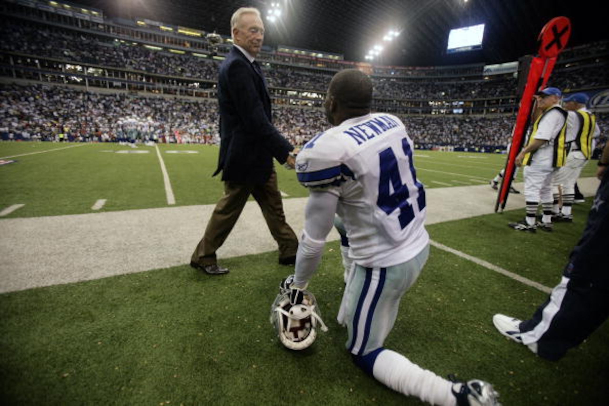 DALLAS - SEPTEMBER 17:  Dallas Cowboys team owner Jerry Jones greets cornerback Terrence Newman as he strides onto the field before the Cowboys play against the Washington Redskins at Texas Stadium in Dallas, Texas on September 17, 2006. Dallas eventually