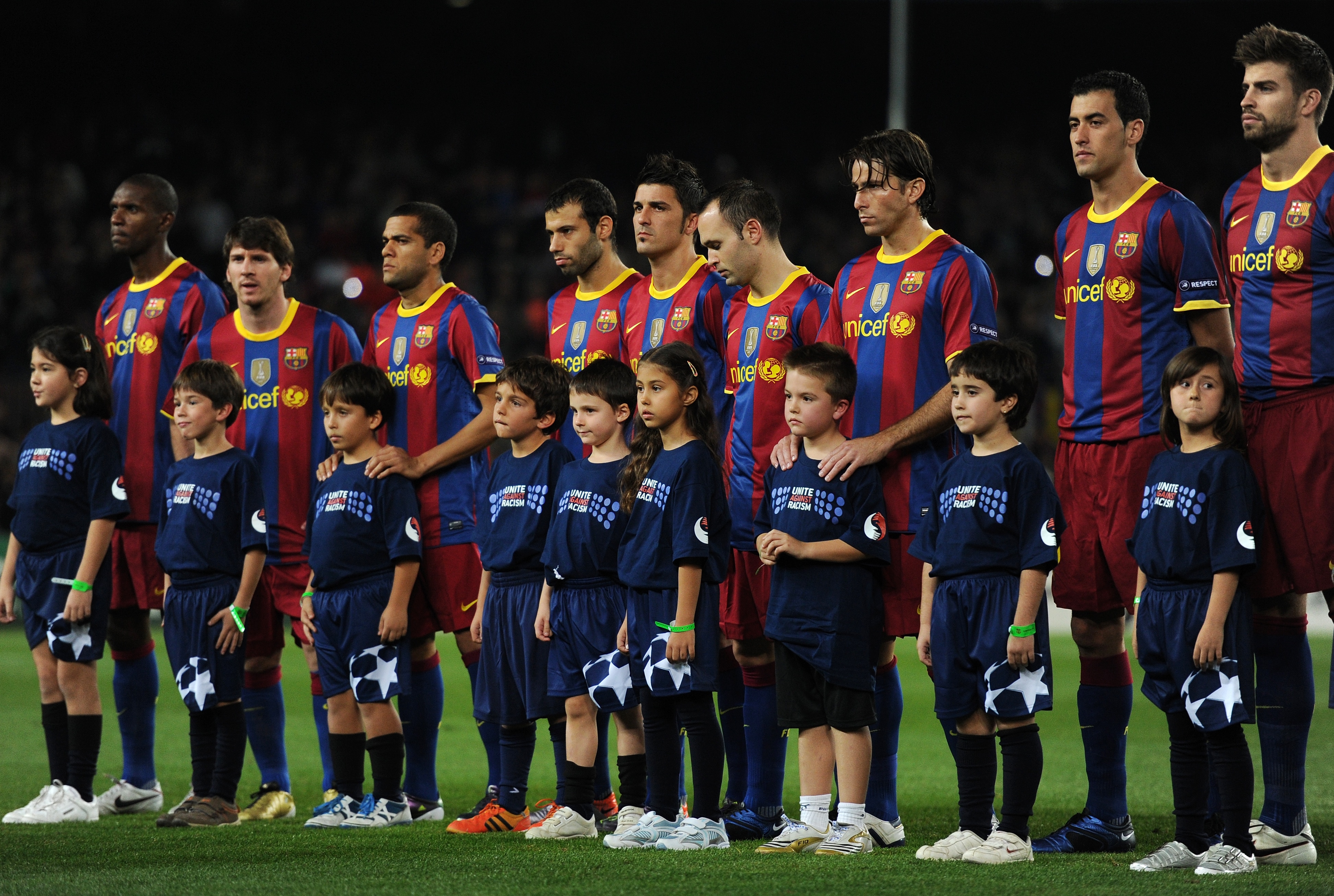BARCELONA, SPAIN - OCTOBER 20:  Mascots wearing Unite Against Racism shirts pose with Barcelona players prior to the start of the UEFA Champions League group D match between Barcelona and FC Copenhagen at the Camp Nou stadium on October 20, 2010 in Barcel