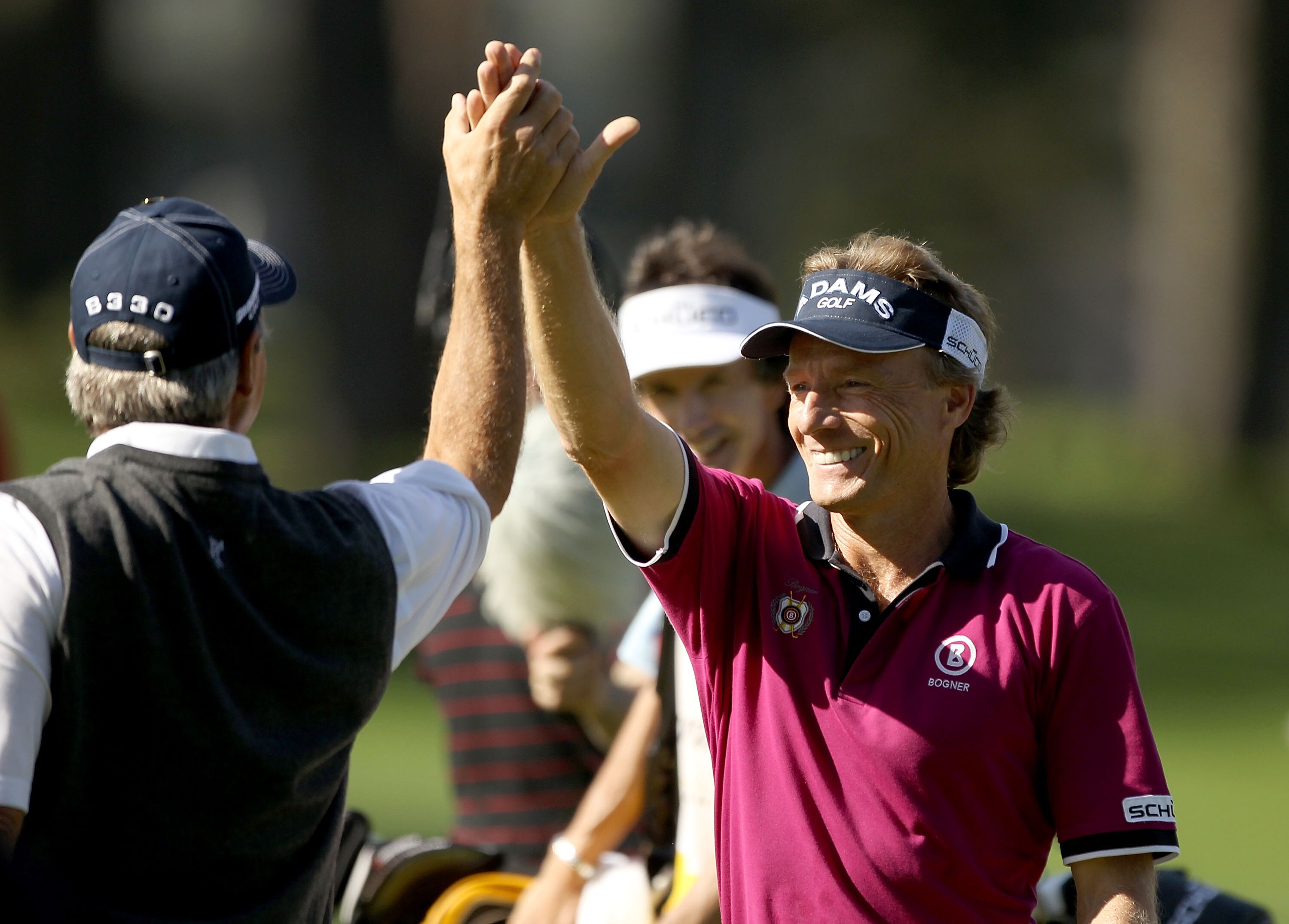 SAN FRANCISCO - NOVEMBER 04:  Bernhard Langer of Germany high fives Fred Couples of the USA after hitting a hole-in-one on the third hole of round 1 of the Charles Schwab Cup Championship at Harding Park Golf Course on November 4, 2010 in San Francisco, C