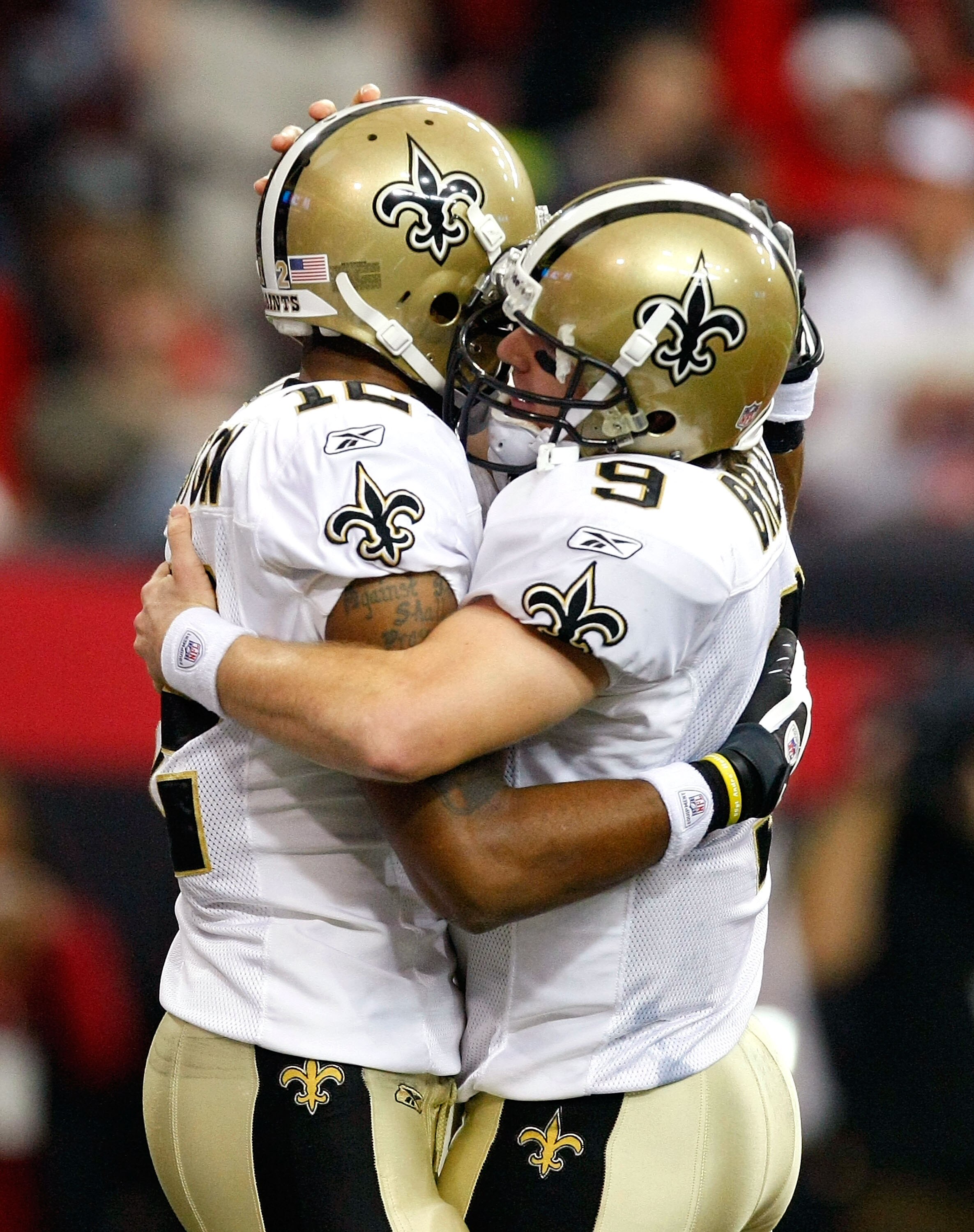 ATLANTA - DECEMBER 13:  Marques Colston #12 and quarterback Drew Brees #9 (R) of the New Orleans Saints celebrate Colston's 3-yard touchdown reception in the second quarter against the Atlanta Falcons at Georgia Dome on December 13, 2009 in Atlanta, Georg