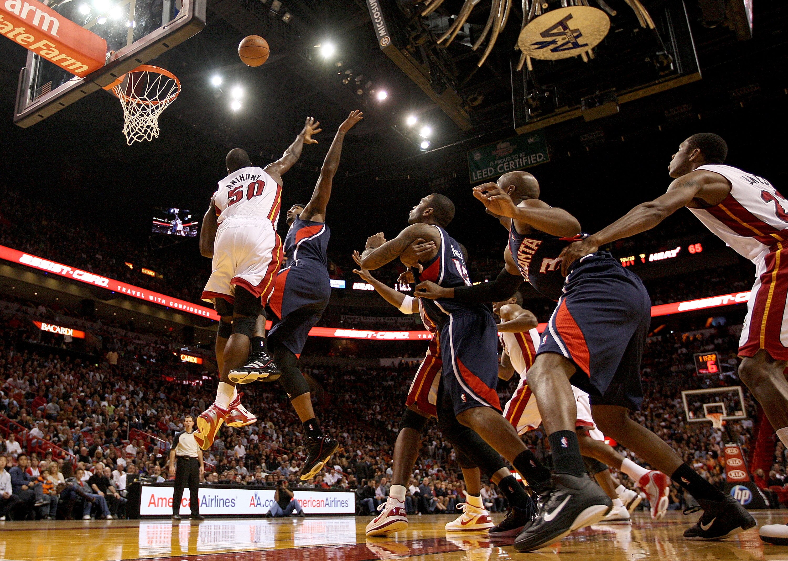 MIAMI, FL - DECEMBER 04:  Josh Smith #5 of the Atlanta Hawks drives to the basket against Joel Anthony #50 of  the Miami Heat during a game at American Airlines Arena on December 4, 2010 in Miami, Florida. NOTE TO USER: User expressly acknowledges and agr