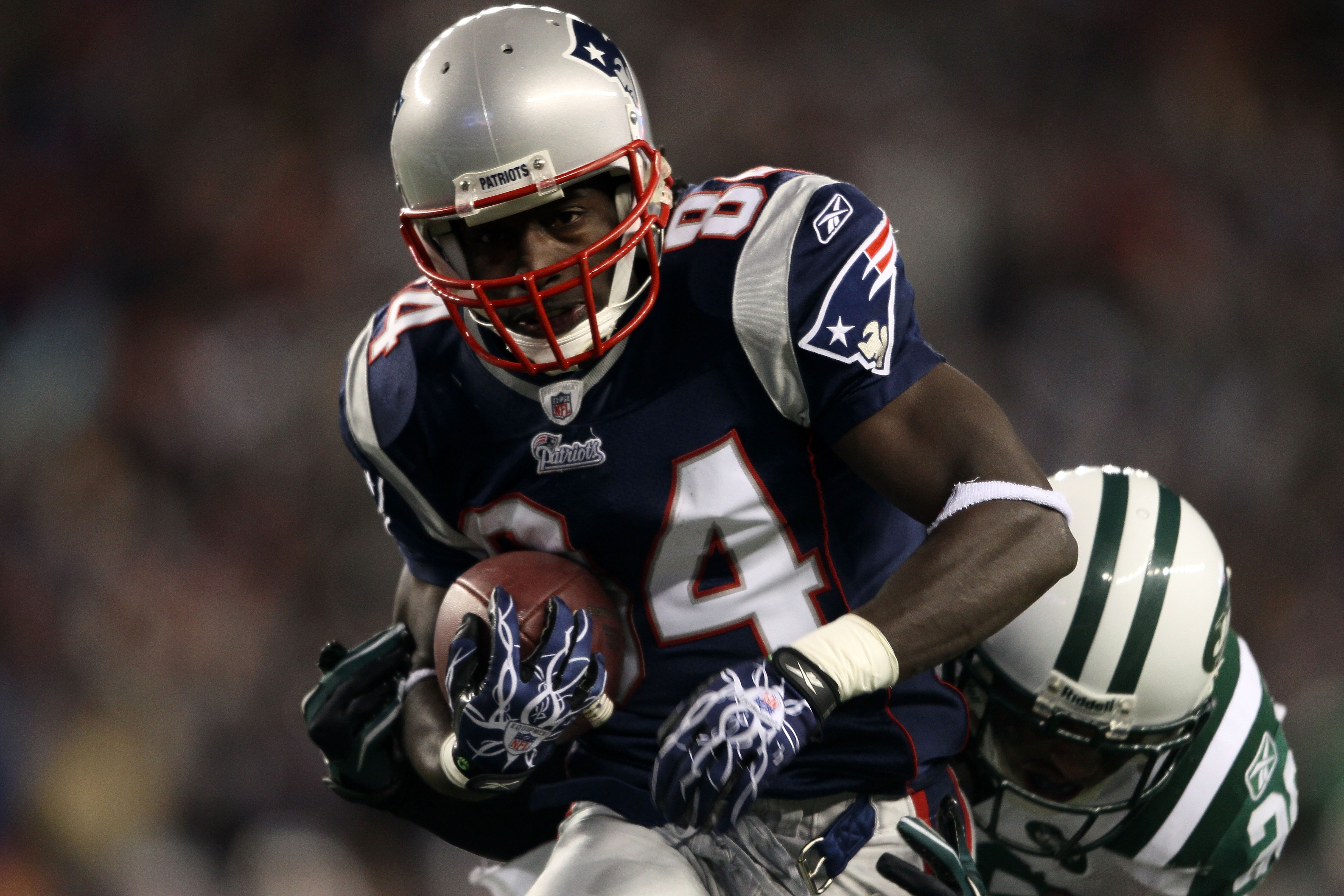 FOXBORO, MA - DECEMBER 06:  Deion Branch #84 of the New England Patriots scores on a 25-yard touchdown reception in the first quarter against the New York Jets at Gillette Stadium on December 6, 2010 in Foxboro, Massachusetts.  (Photo by Elsa/Getty Images
