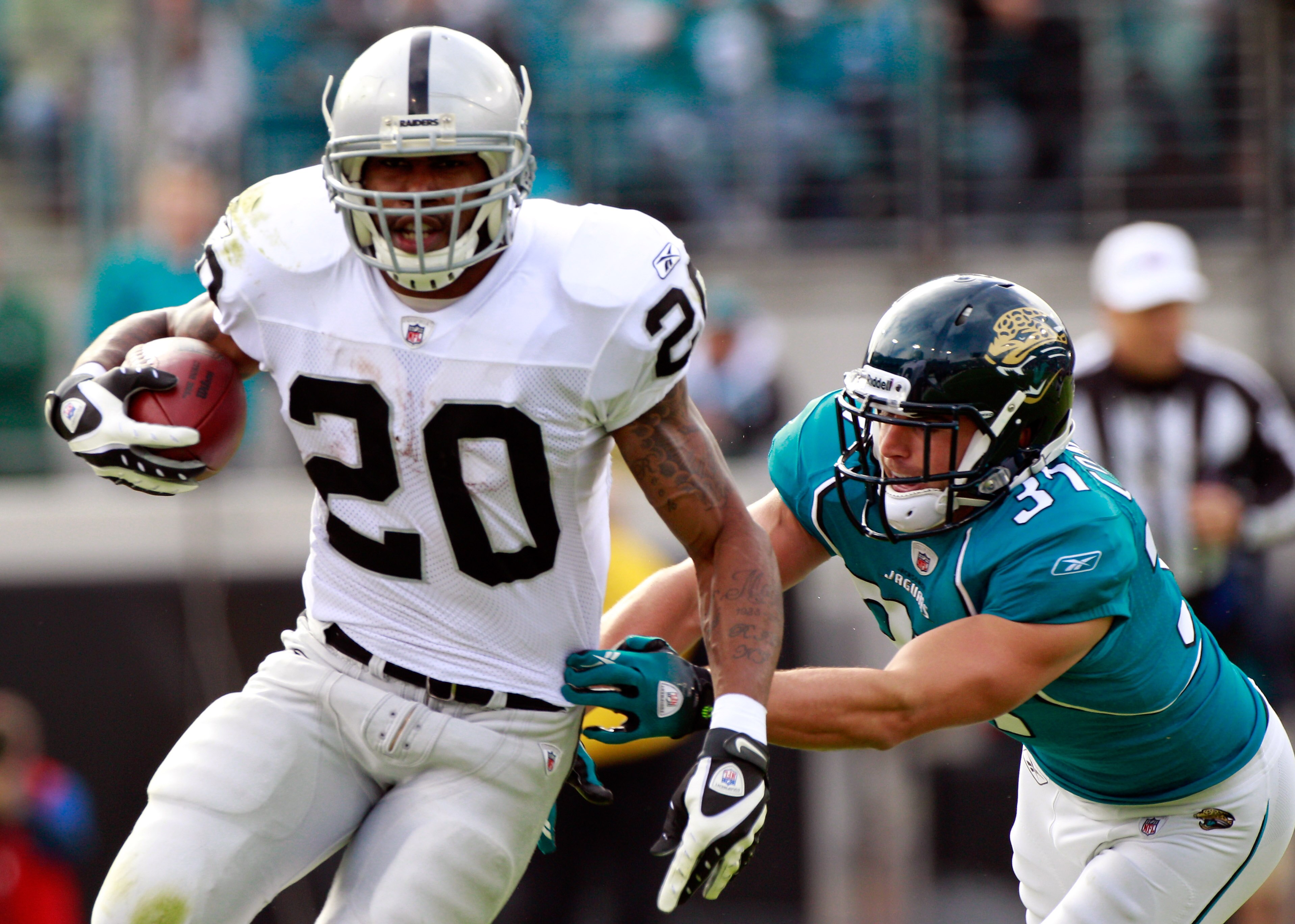 JACKSONVILLE, FL - DECEMBER 12:  Sean Considine #37 of the Jacksonville Jaguars attempts to tackle Darren McFadden #20 of the Oakland Raiders during the game at EverBank Field on December 12, 2010 in Jacksonville, Florida.  (Photo by Sam Greenwood/Getty I