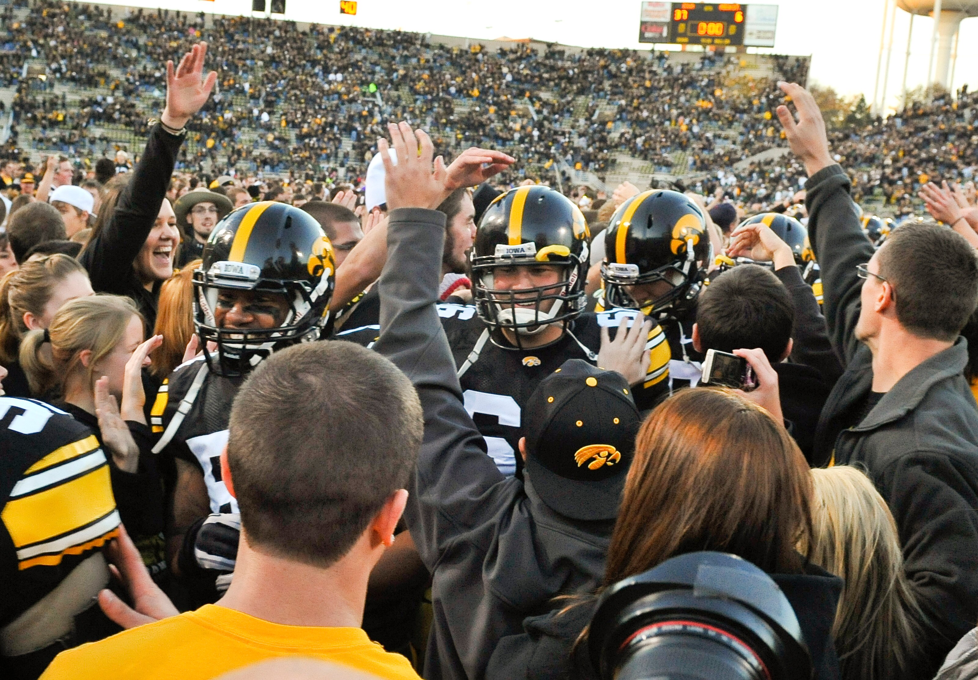 IOWA CITY, IA - OCTOBER 30:  University of Iowa Hawkeyes players celebrate with fans after they defeated the Michigan State Spartans at Kinnick Stadium on October 30, 2010 in Iowa City, Iowa. Iowa won 37-6 over Michigan State. (Photo by David Purdy/Getty