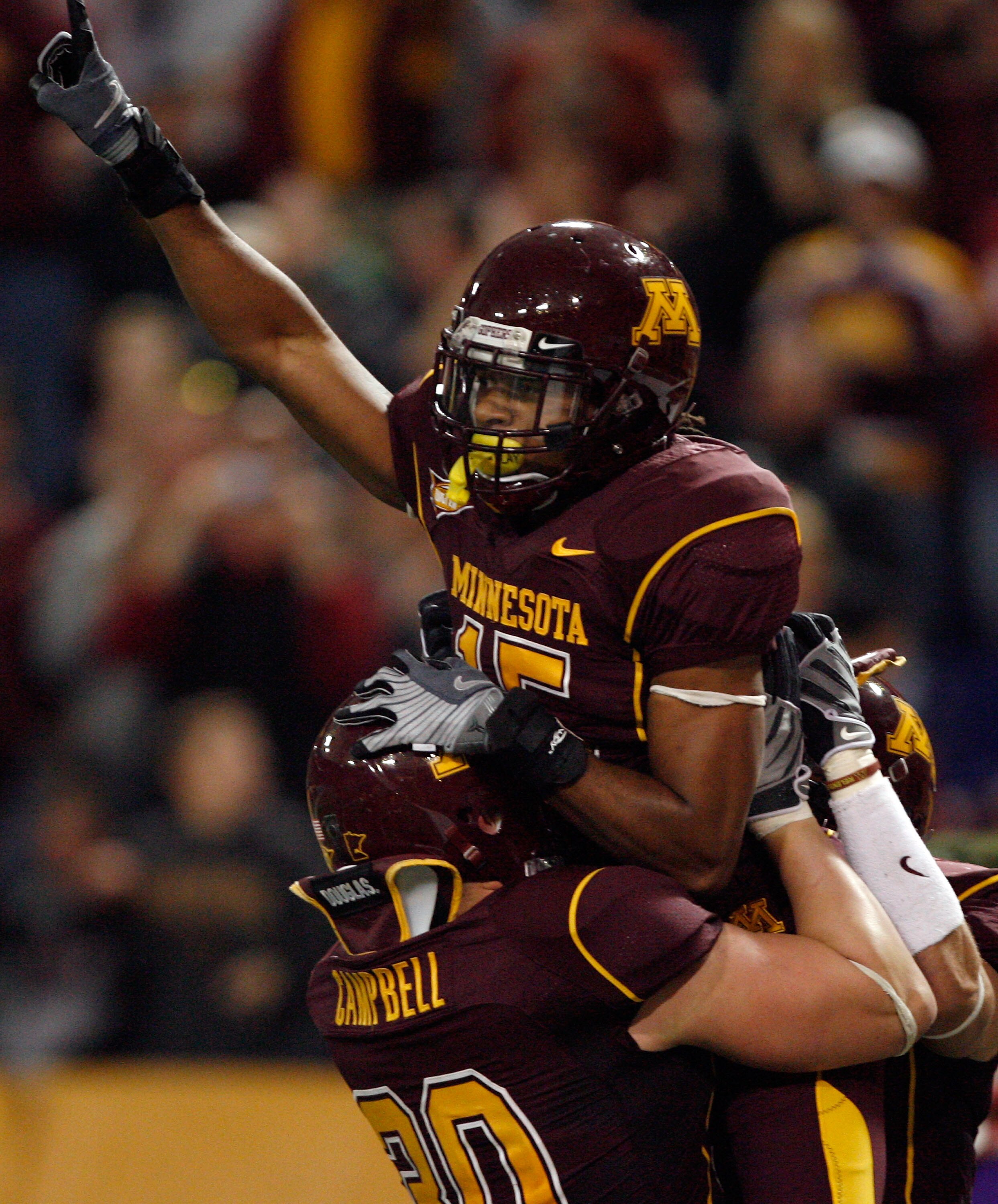 MINNEAPOLIS - NOVEMBER 01:  Traye Simmons #15 of the Minnesota Golden Gophers celebrates his interception for a touchdown for a 14-10 lead with Lee Campbell #30 over the Northwestern Wildcats during the second quarter at the Hubert H.Humphrey Metrodome on