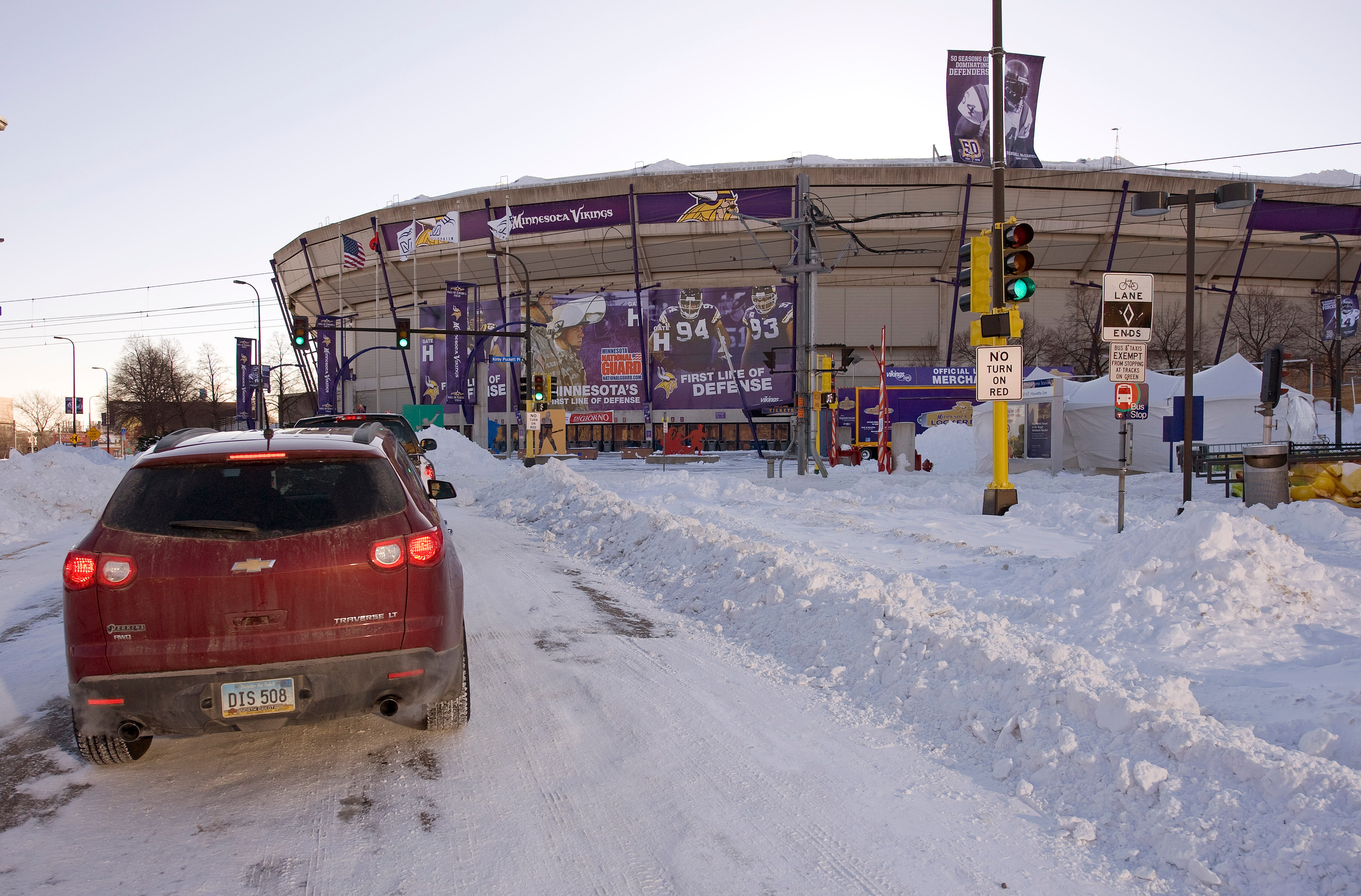 MINNEAPOLIS, MN - DECEMBER 12:  Cars pass the Hubert H. Humphrey Metrodome, Mall of America Stadium where the inflatable roof collapsed under the weight of snow during a storm Sunday morning December 12, 2010 in Minneapolis, Minnesota. A blizzard dumped m