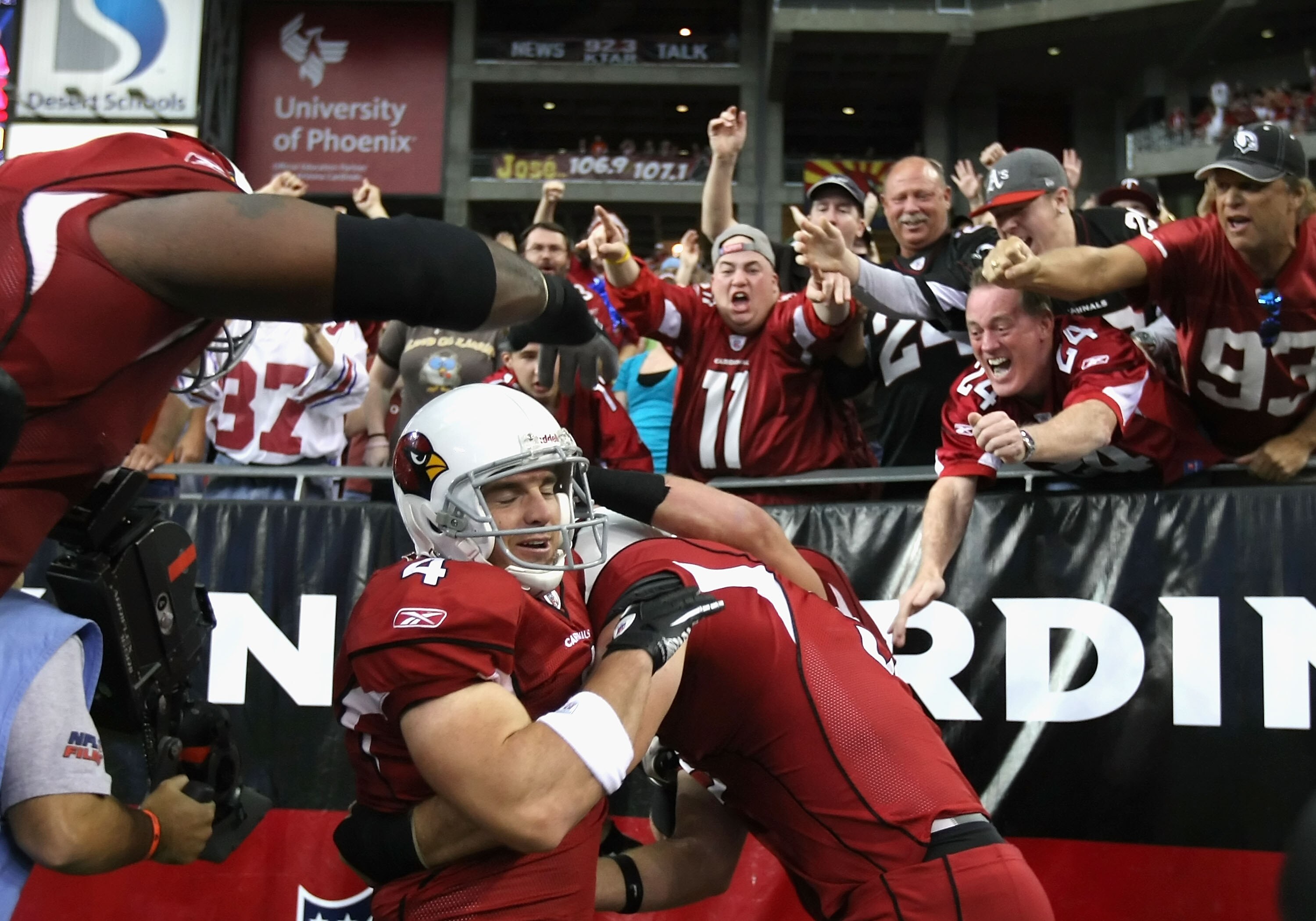 GLENDALE, AZ - DECEMBER 12:  Place kicker Jay Feely #4 of the Arizona Cardinals celebrates with teamamtes and fans after scoring on a 5 yard rushing touchdown against the Denver Broncos during the second quarter of the NFL game at the University of Phoeni