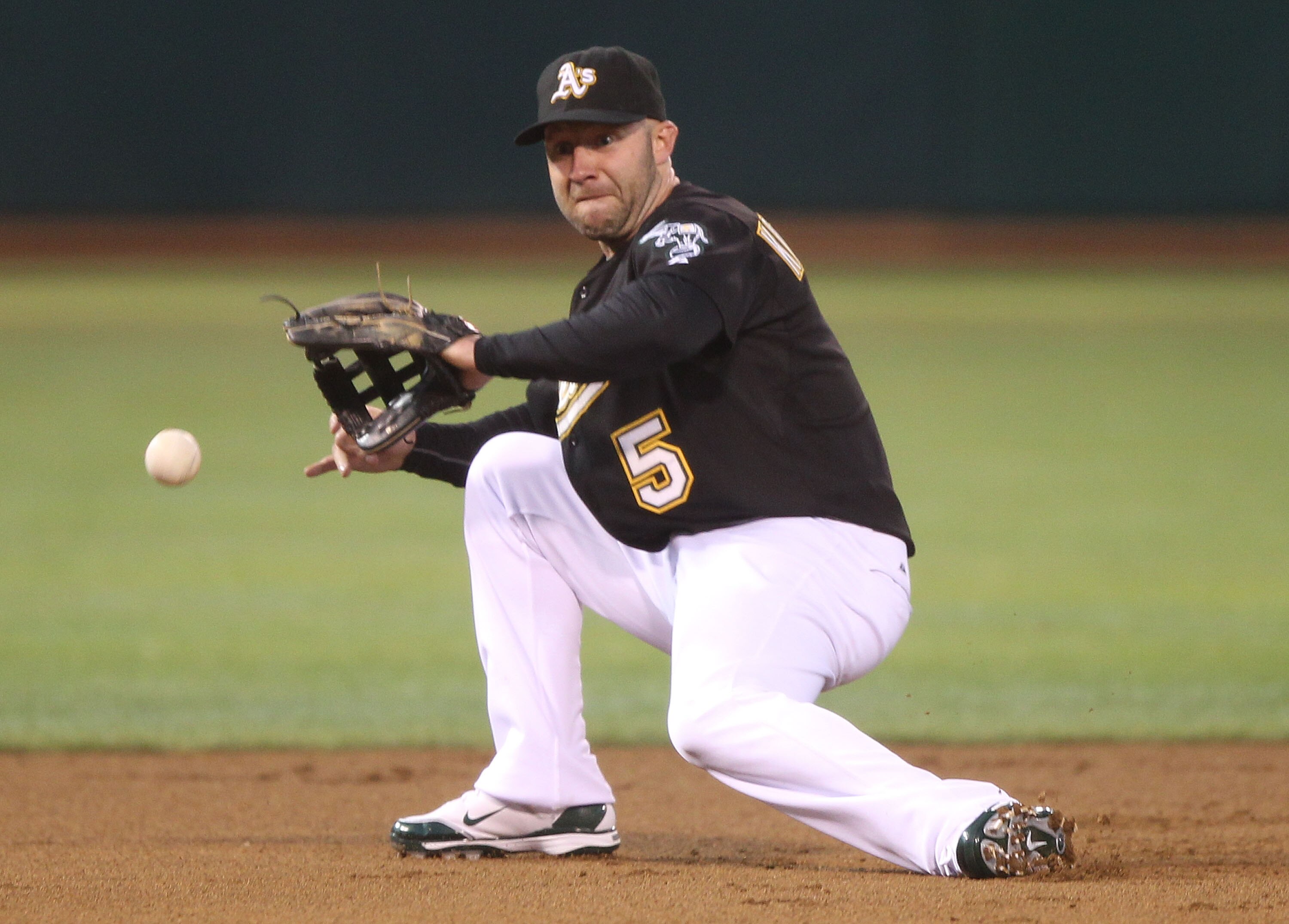 OAKLAND, CA - SEPTEMBER 03:  Kevin Kouzmanoff #5 of the Oakland Athletics fields a ball hit by Juan Rivera of the Los Angeles Angels of Anaheim during a Major League Baseball game at the Oakland-Alameda County Coliseum on September 3, 2010 in Oakland, Cal