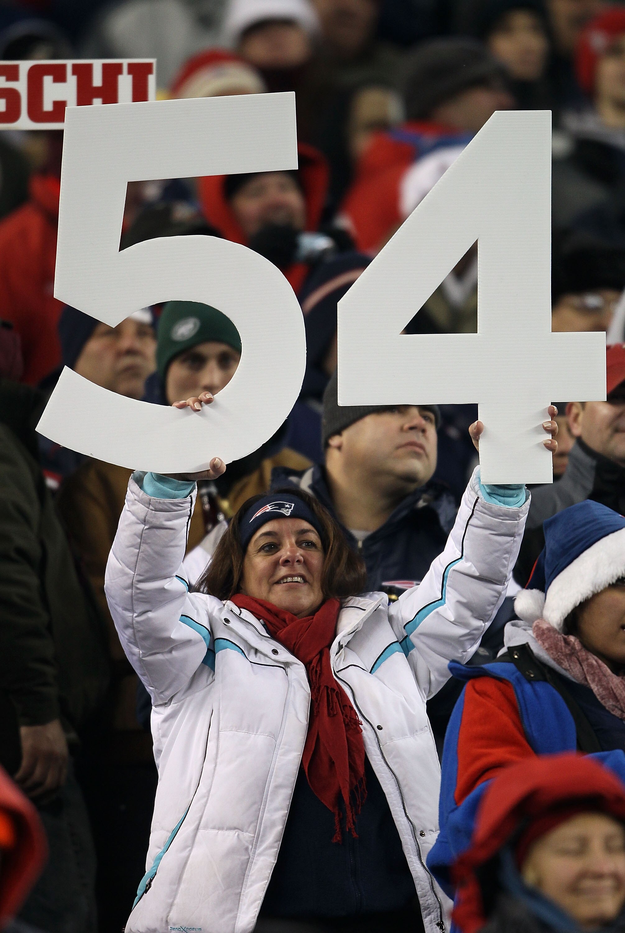 FOXBORO, MA - DECEMBER 06:  A fan of the New England Patriots holds up the #54 in support of former Patriot player Tedy Bruschi during a halftime ceremony celebrating Brushi's playing career against the New York Jets at Gillette Stadium on December 6, 201