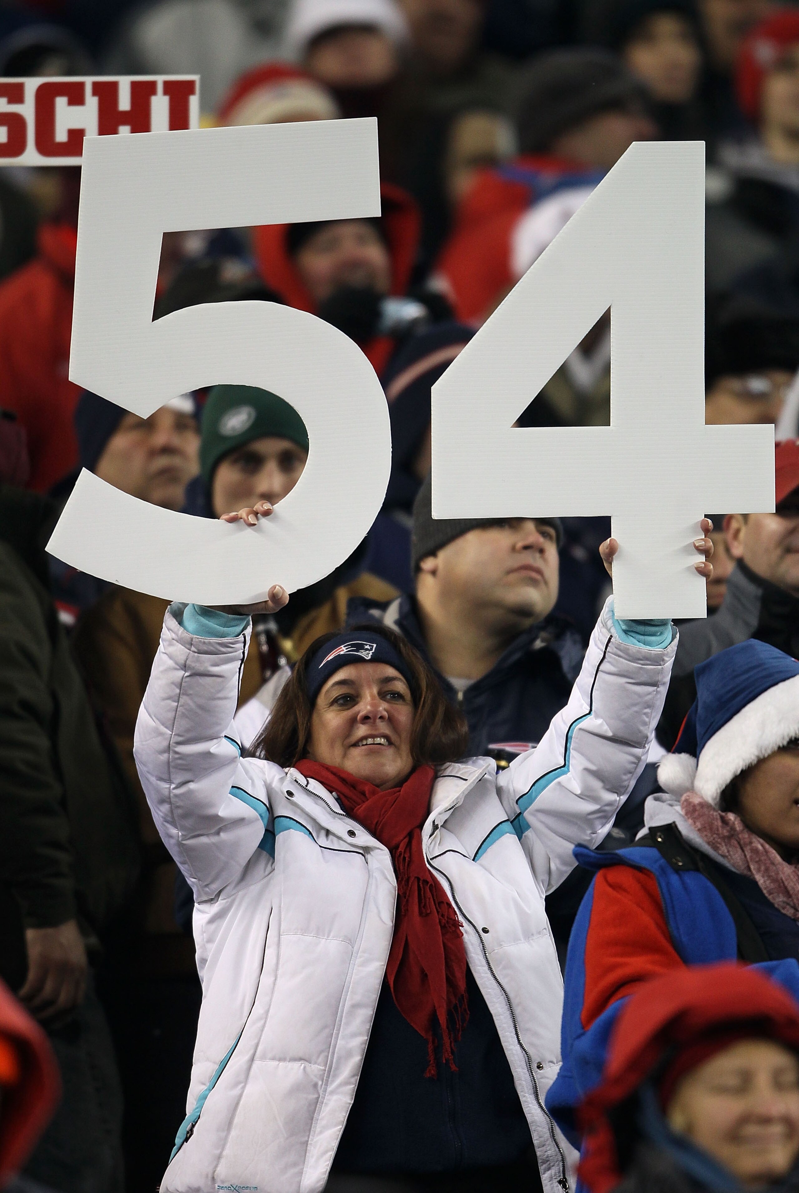 FOXBORO, MA - DECEMBER 06:  A fan of the New England Patriots holds up the #54 in support of former Patriot player Tedy Bruschi during a halftime ceremony celebrating Brushi's playing career against the New York Jets at Gillette Stadium on December 6, 201