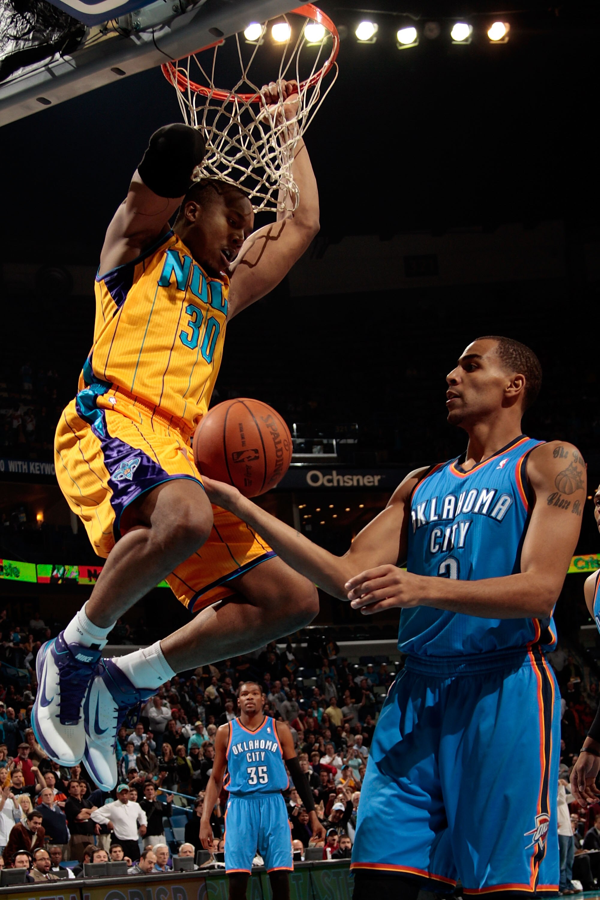 NEW ORLEANS, LA - DECEMBER 10:  David West #30 of the New Orleans Hornets dunks the ball over Thabo Sefolosha #2 of the Oklahoma City Thunder at New Orleans Arena on December 10, 2010 in New Orleans, Louisiana.    NOTE TO USER: User expressly acknowledges