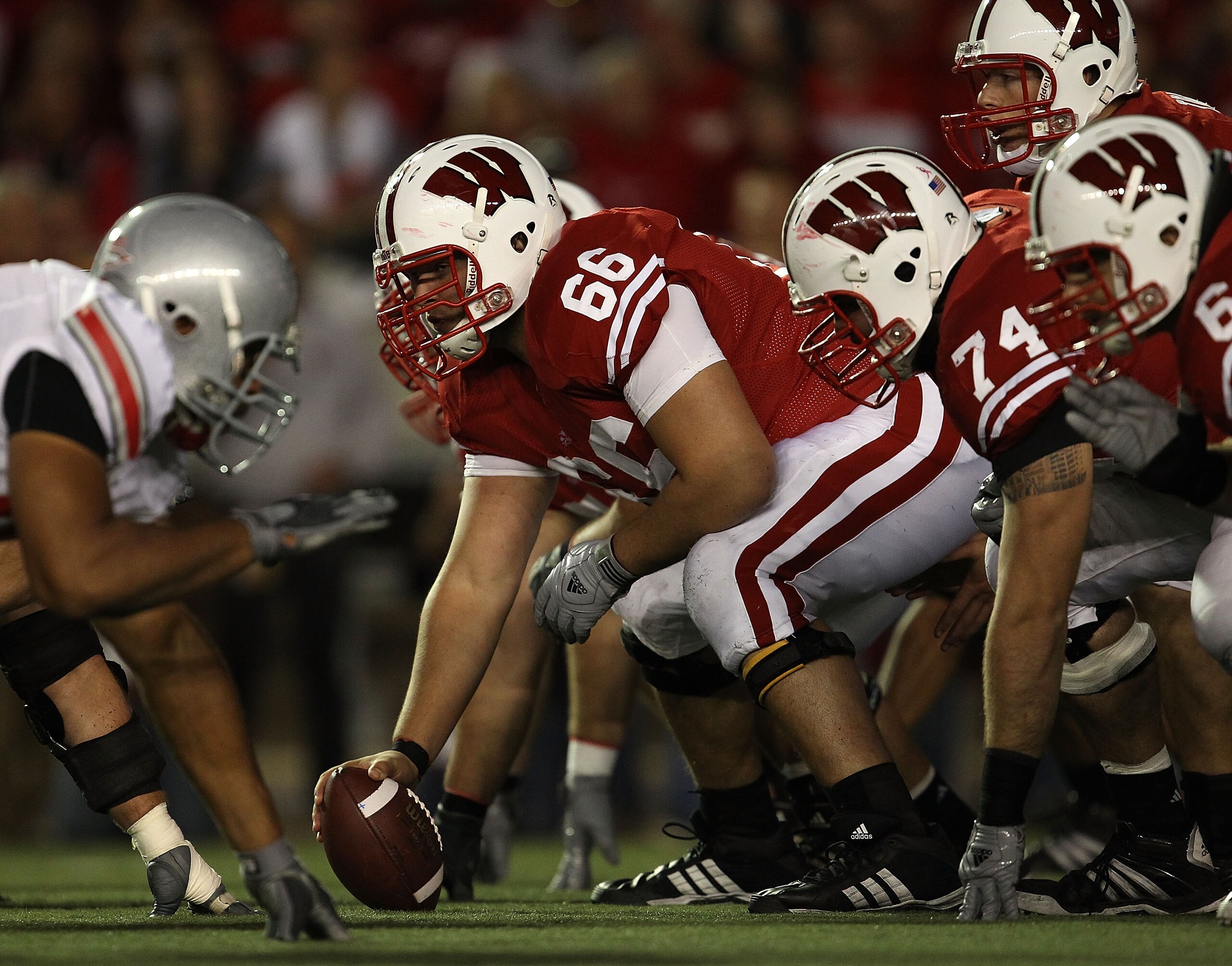 MADISON, WI - OCTOBER 16: Peter Konz #66 of the Wisconsin Badgers prepares to snap the ball to Scott Tolzien #16 against the Ohio State Buckeyes at Camp Randall Stadium on October 16, 2010 in Madison, Wisconsin. Wisconsin defeated Ohio State 31-18. (Photo