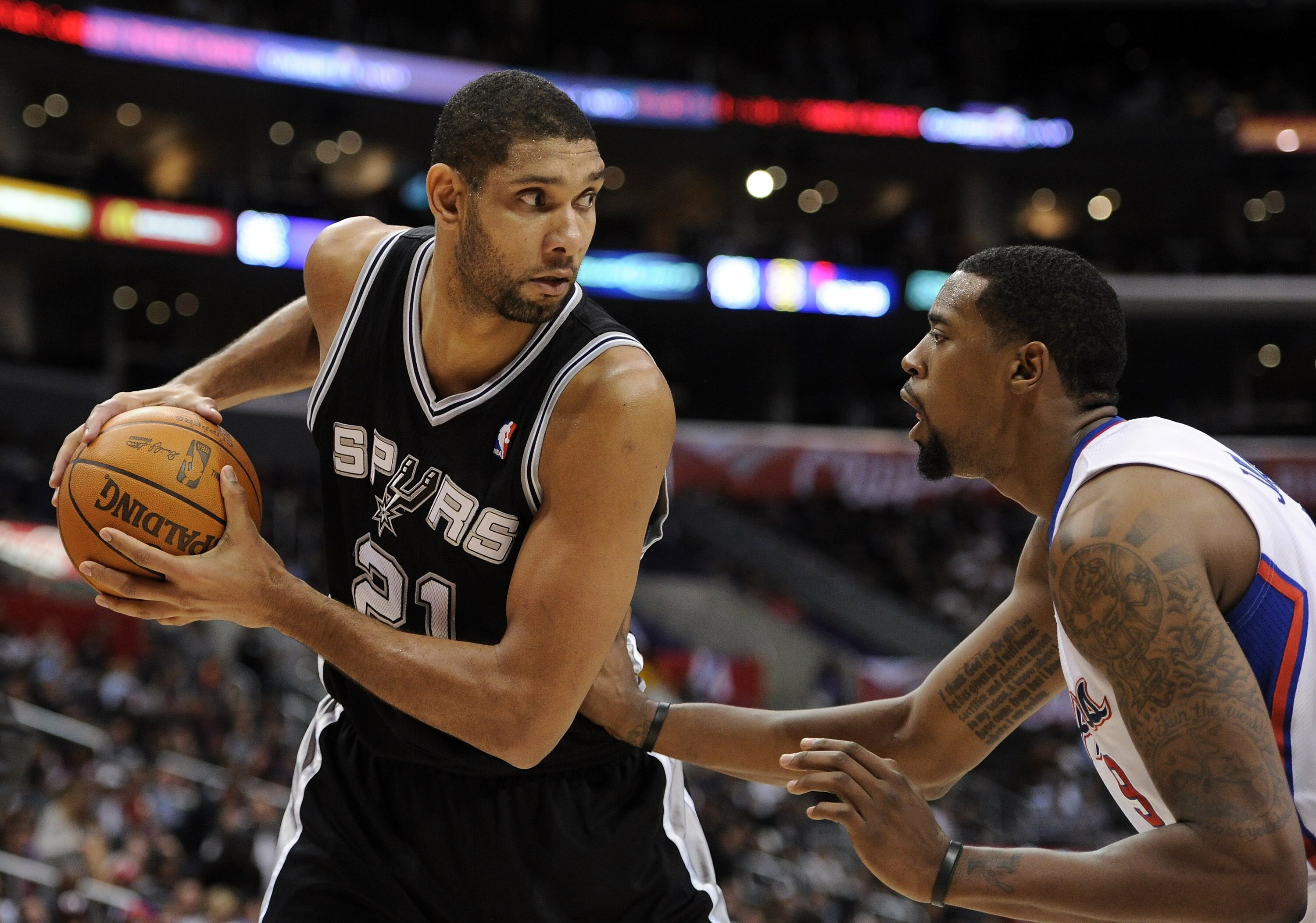 LOS ANGELES, CA - DECEMBER 01:  Tim Duncan #21 of the San Antonio Spurs pauses with the ball in front of DeAndre Jordan #9 of the Los Angeles Clippers at the Staples Center on December 1, 2010 in Los Angeles, California.  NOTE TO USER: User expressly ackn