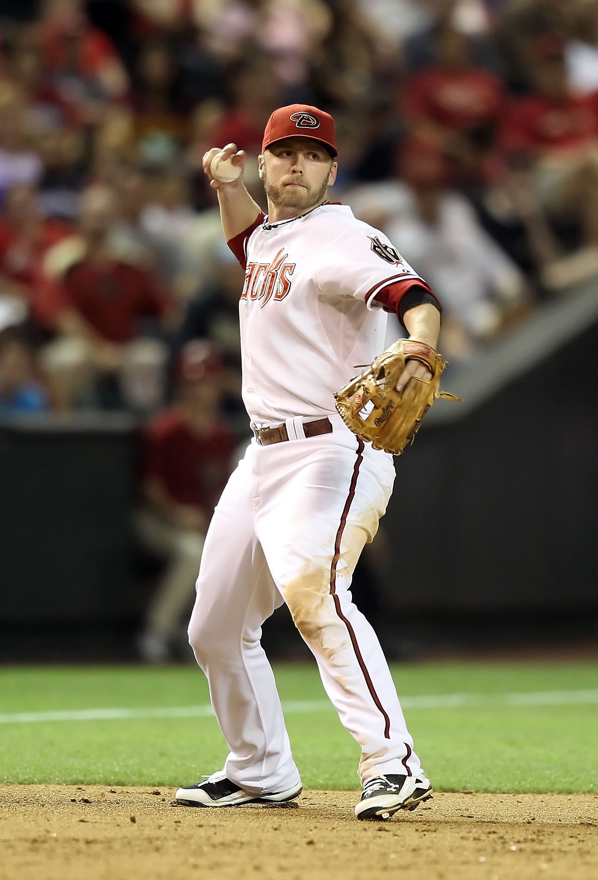 PHOENIX - JUNE 11:  Infielder Mark Reynolds #27 of the Arizona Diamondbacks fields a ground ball out against the St. Louis Cardinals during the Major League Baseball game at Chase Field on June 11, 2010 in Phoenix, Arizona.  The Cardinals defeated the Dia