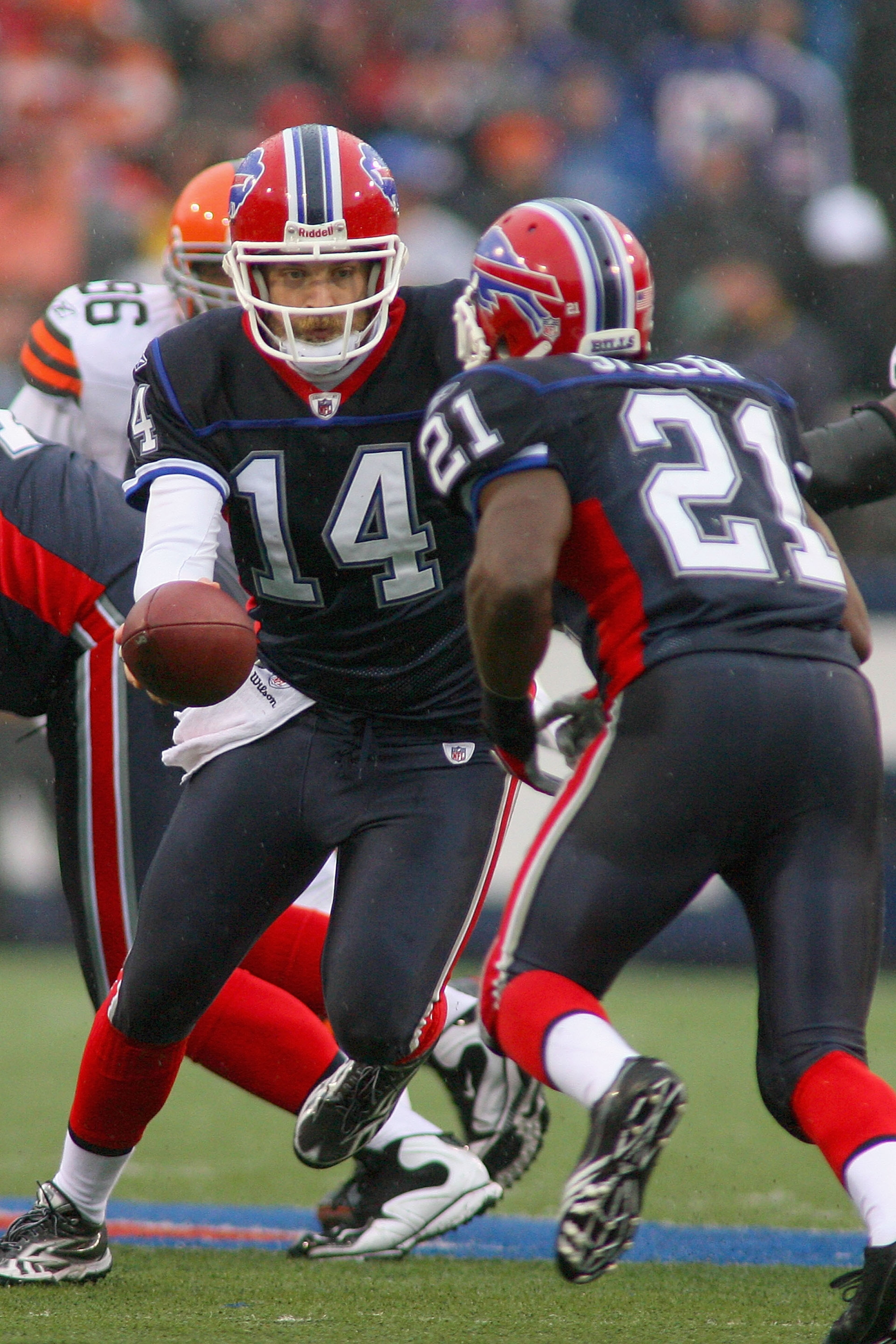 ORCHARD PARK, NY - DECEMBER 12:  Ryan Fitzpatrick #14 of the Buffalo Bills hands off to C.J. Spiller #21 against the Cleveland Browns at Ralph Wilson Stadium on December 12, 2010 in Orchard Park, New York. Buffalo won 13-6.  (Photo by Rick Stewart/Getty I