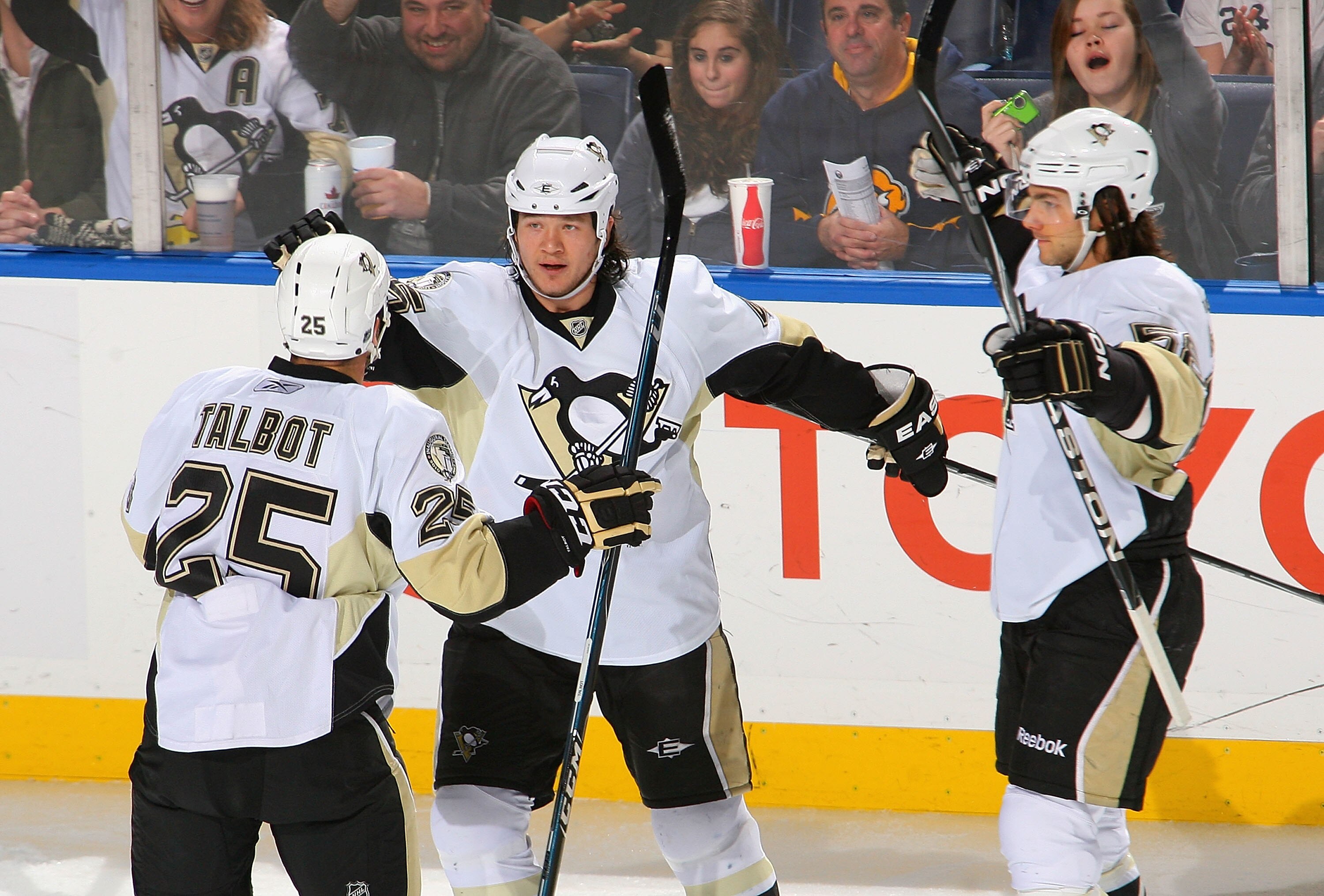 BUFFALO, NY - DECEMBER 11: Maxime Talbot #25, Arron Asham #45 and Kris Letang #58 of the Pittsburgh Penguins celebrate Asham's goal in the first period against the Buffalo Sabres  at HSBC Arena on December 11, 2010 in Buffalo, New York.  (Photo by Rick St