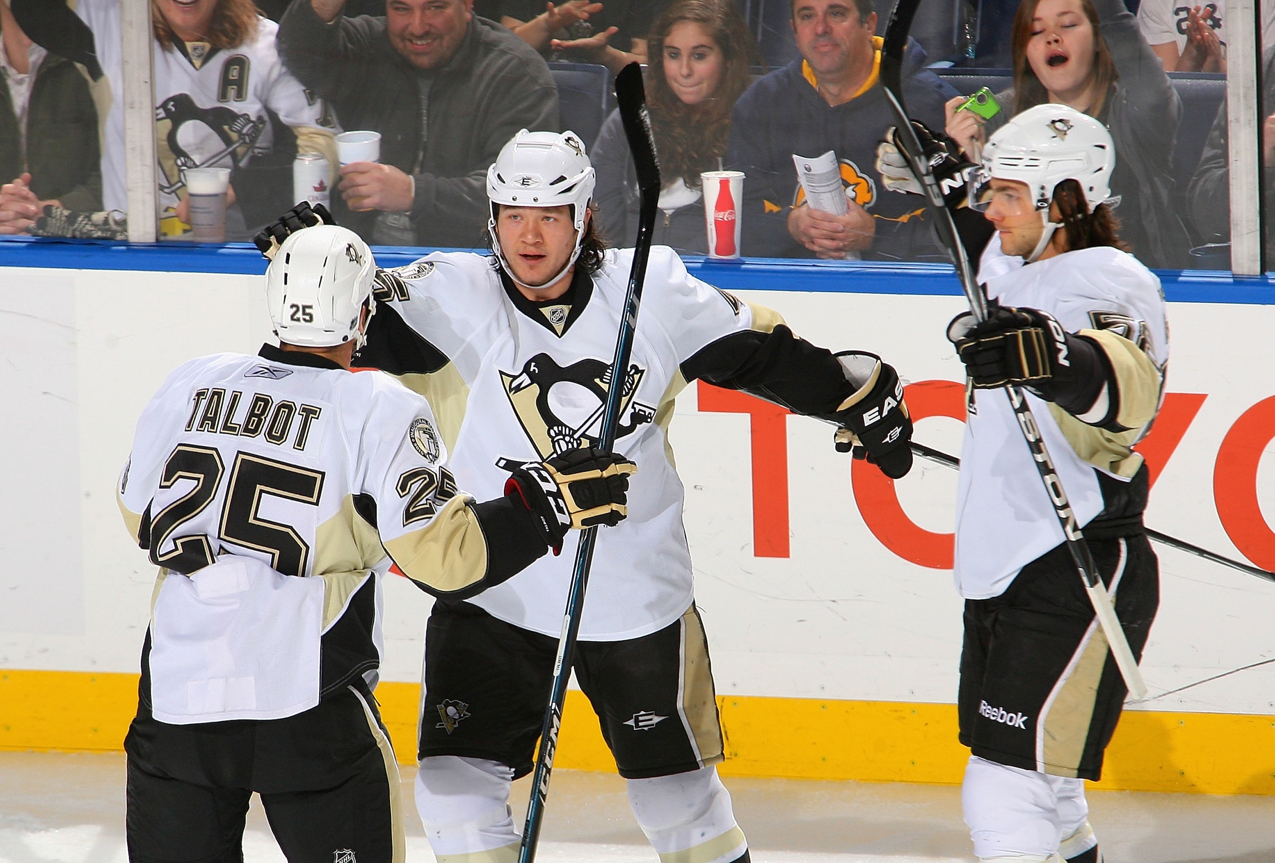 BUFFALO, NY - DECEMBER 11: Maxime Talbot #25, Arron Asham #45 and Kris Letang #58 of the Pittsburgh Penguins celebrate Asham's goal in the first period against the Buffalo Sabres  at HSBC Arena on December 11, 2010 in Buffalo, New York.  (Photo by Rick St