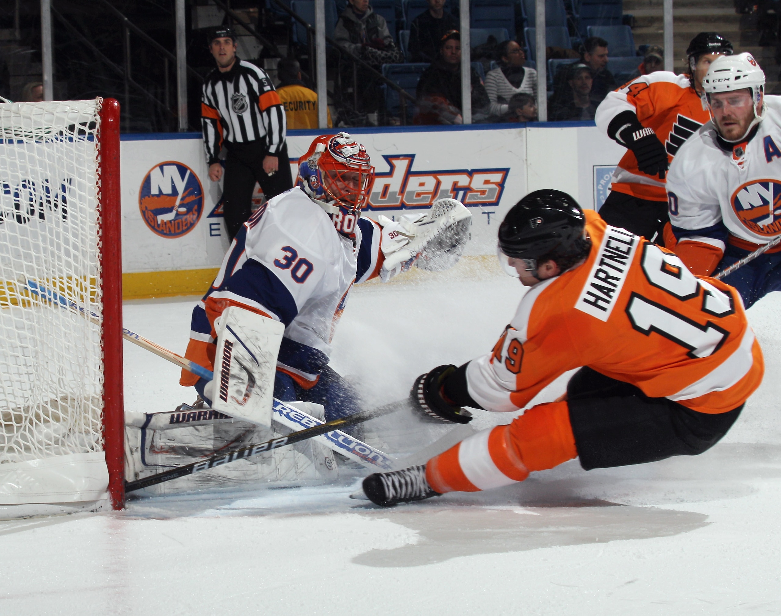 UNIONDALE, NY - DECEMBER 05: Scott Hartnell #19 of the Philadelphia Flyers is tripped up as he attempts to reach a puck against Dwayne Roloson #30 of the New York Islanders at the Nassau Coliseum on December 5, 2010 in Uniondale, New York.  (Photo by Bruc