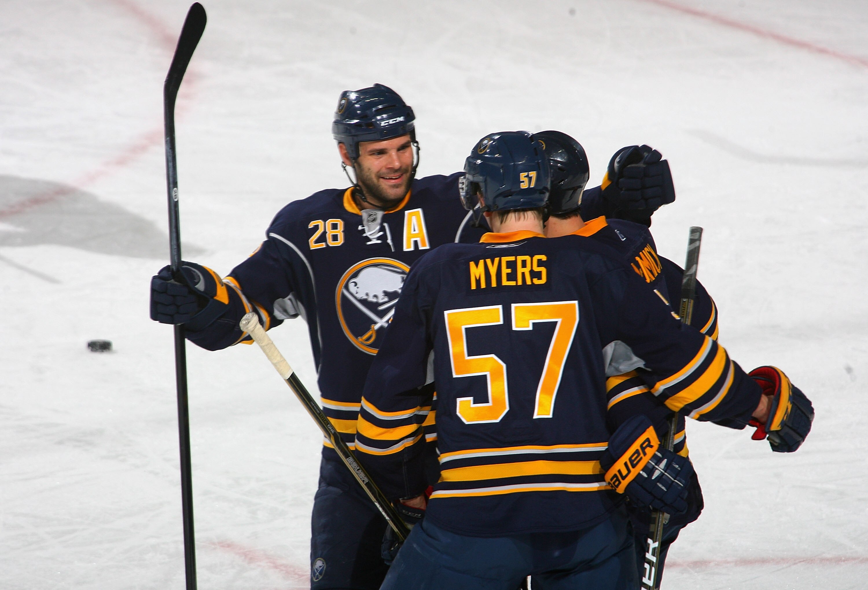 BUFFALO, NY - DECEMBER 09: Paul Gaustad #28, Tyler Myers #57 and Cody McCormick #8  of the Buffalo Sabres celebrate McCormick's goal in the first period against the San Jose Sharks at HSBC Arena on December 9, 2010 in Buffalo, New York.  (Photo by Rick St