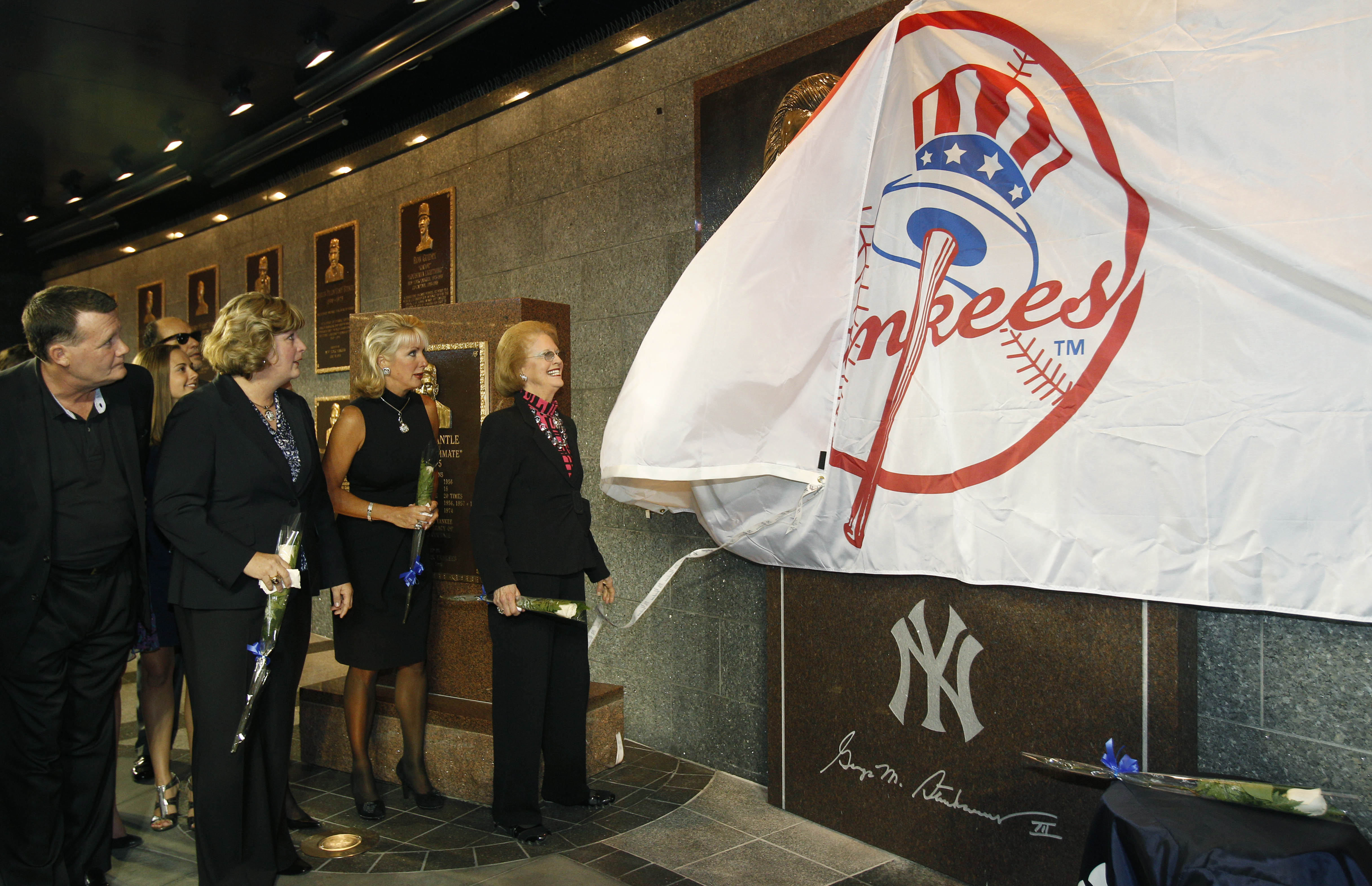 NEW YORK - SEPTEMBER 20:  Members of the Steinbrenner family watch as Steinbrenner's widow Joan pulls a Yankees banner down to reveal  a monument to the late Yankees principal owner George Steinbrenner during a dedication ceremony before the Yankees baseb