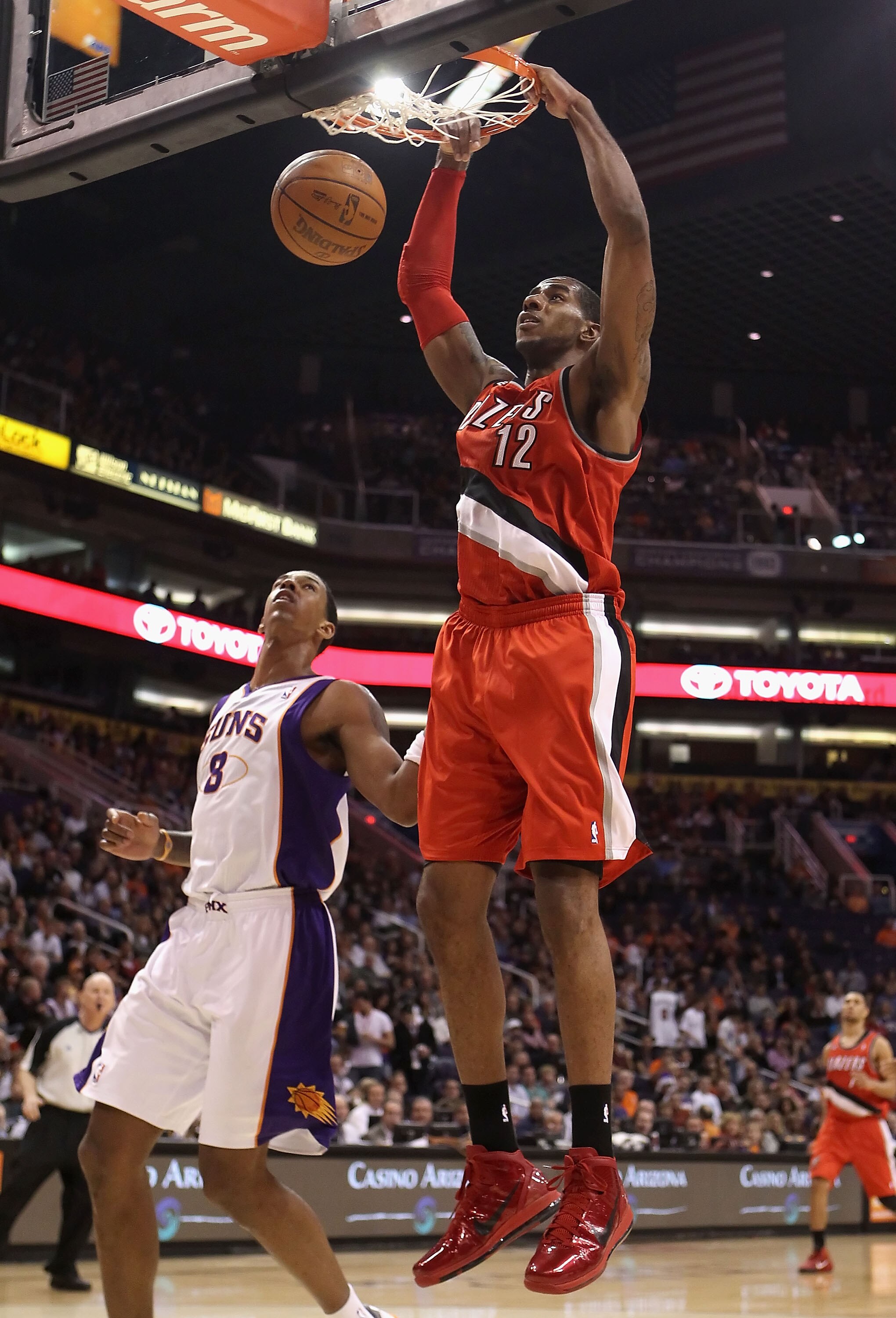 PHOENIX - DECEMBER 10:  LaMarcus Aldridge #12 of the Portland Trail Blazers slam dunks the ball over Channing Frye #8 of the Phoenix Suns during the NBA game at US Airways Center on December 10, 2010 in Phoenix, Arizona. The Trail Blazers defeated the Sun