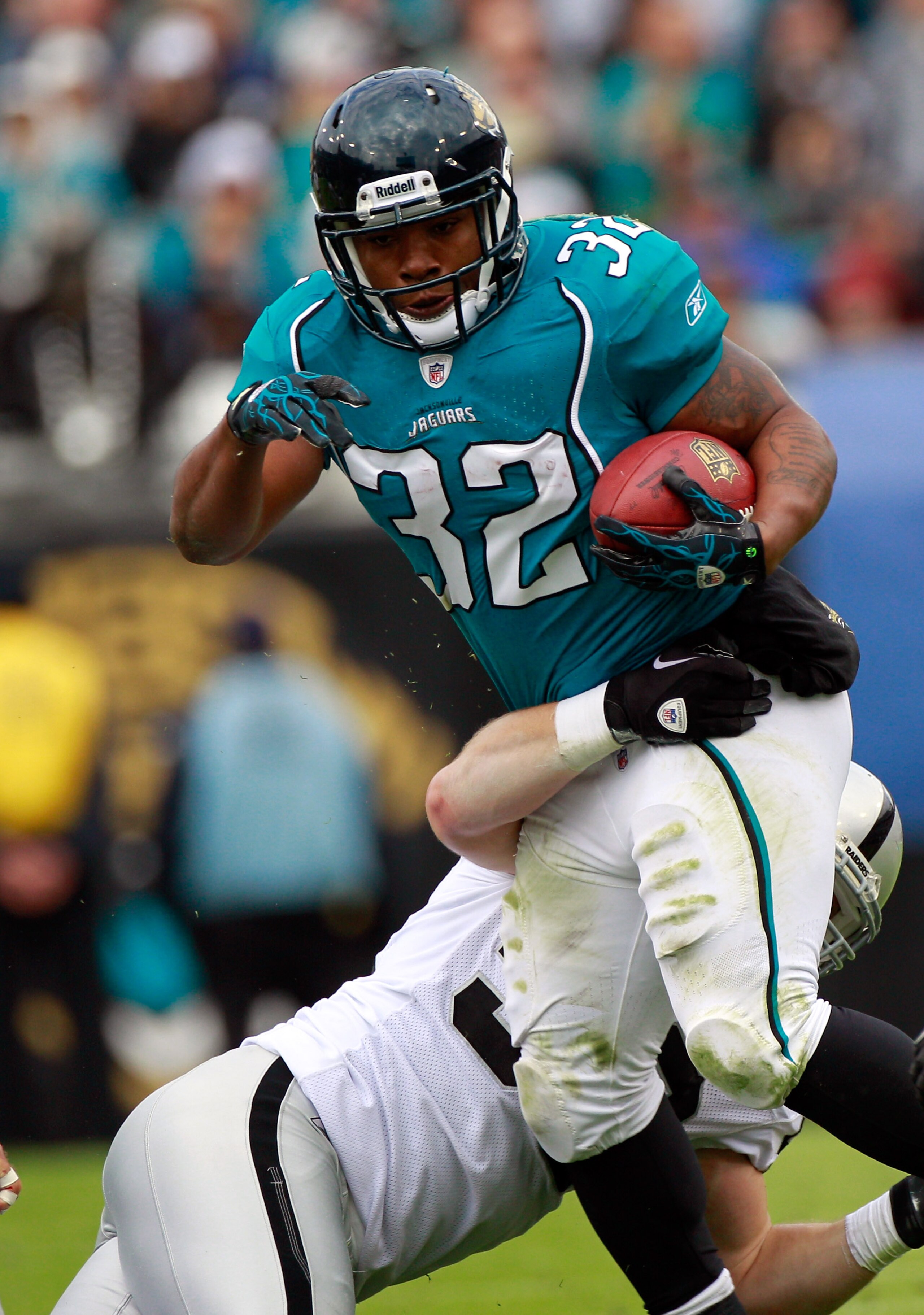 JACKSONVILLE, FL - DECEMBER 12:  Travis Goethel #50 of the Oakland Raiders attempts to tackle Maurice Jone-Drew #32 of the Jacksonville Jaguars during the game at EverBank Field on December 12, 2010 in Jacksonville, Florida.  (Photo by Sam Greenwood/Getty
