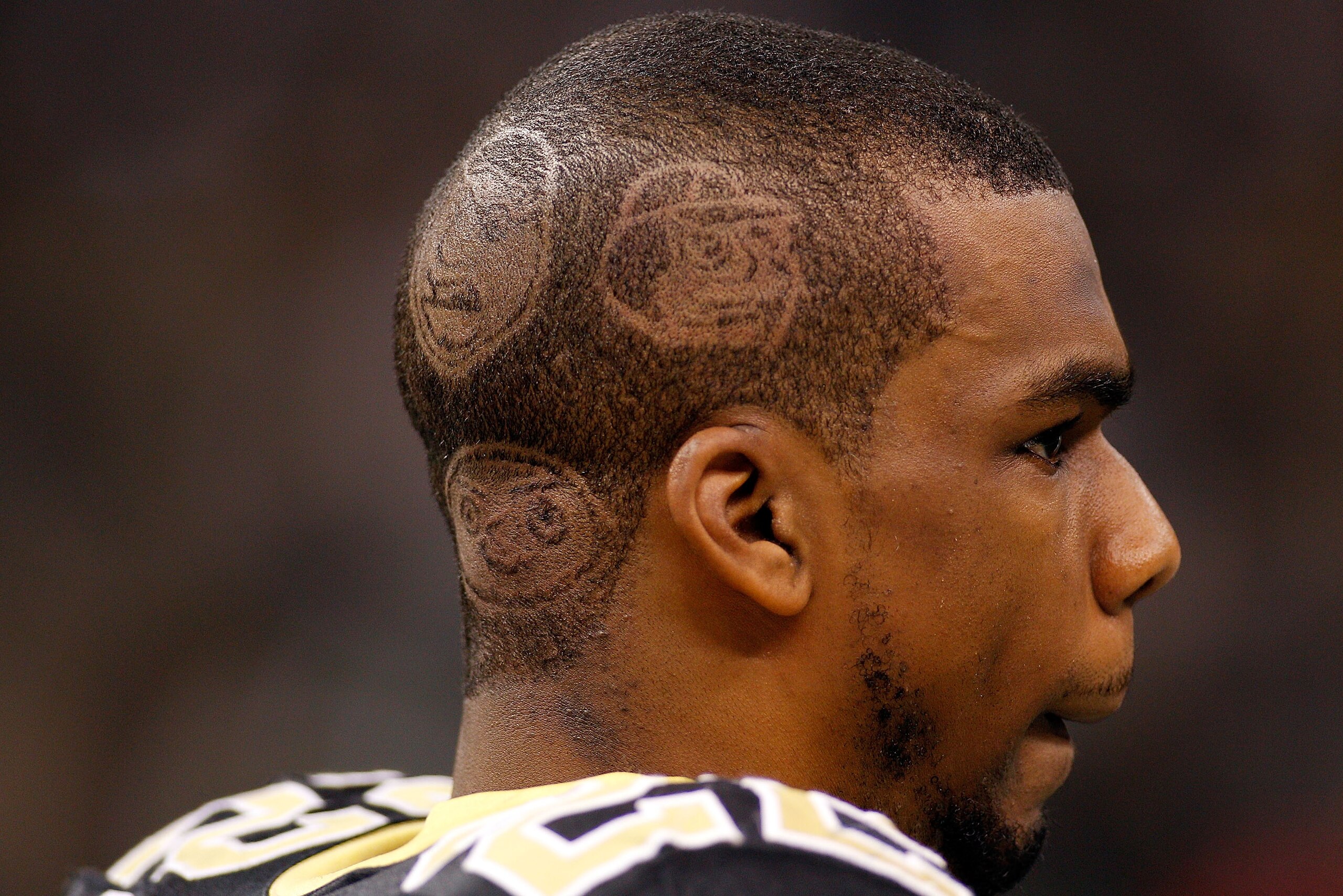 NEW ORLEANS, LA - DECEMBER 12:  Tracy Porter has the cast of 'Family Guy' shaved into his head for the game against the St. Louis Rams of the New Orleans Saints at the Louisiana Superdome on December 12, 2010 in New Orleans, Louisiana.  (Photo by Chris Gr