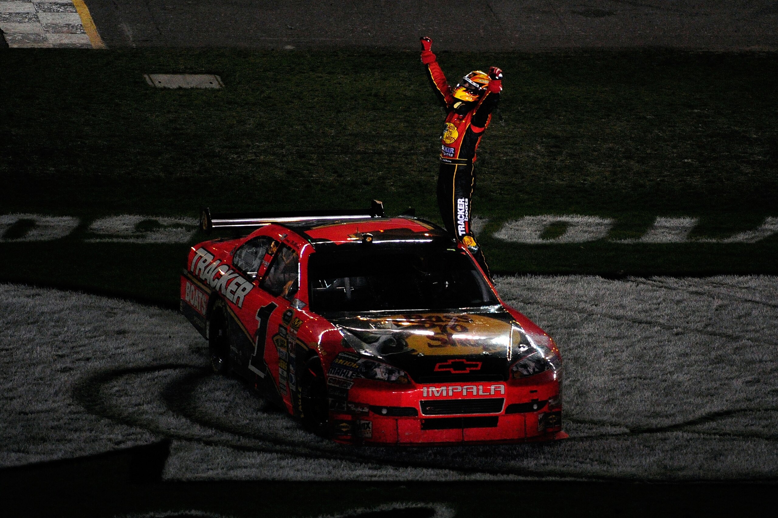 DAYTONA BEACH, FL - FEBRUARY 14:  Jamie McMurray climbs on top of his #1 Bass Tracker Chevrolet to celebrate winning the NASCAR Sprint Cup Series Daytona 500 at Daytona International Speedway on February 14, 2010 in Daytona Beach, Florida.  (Photo by Sam