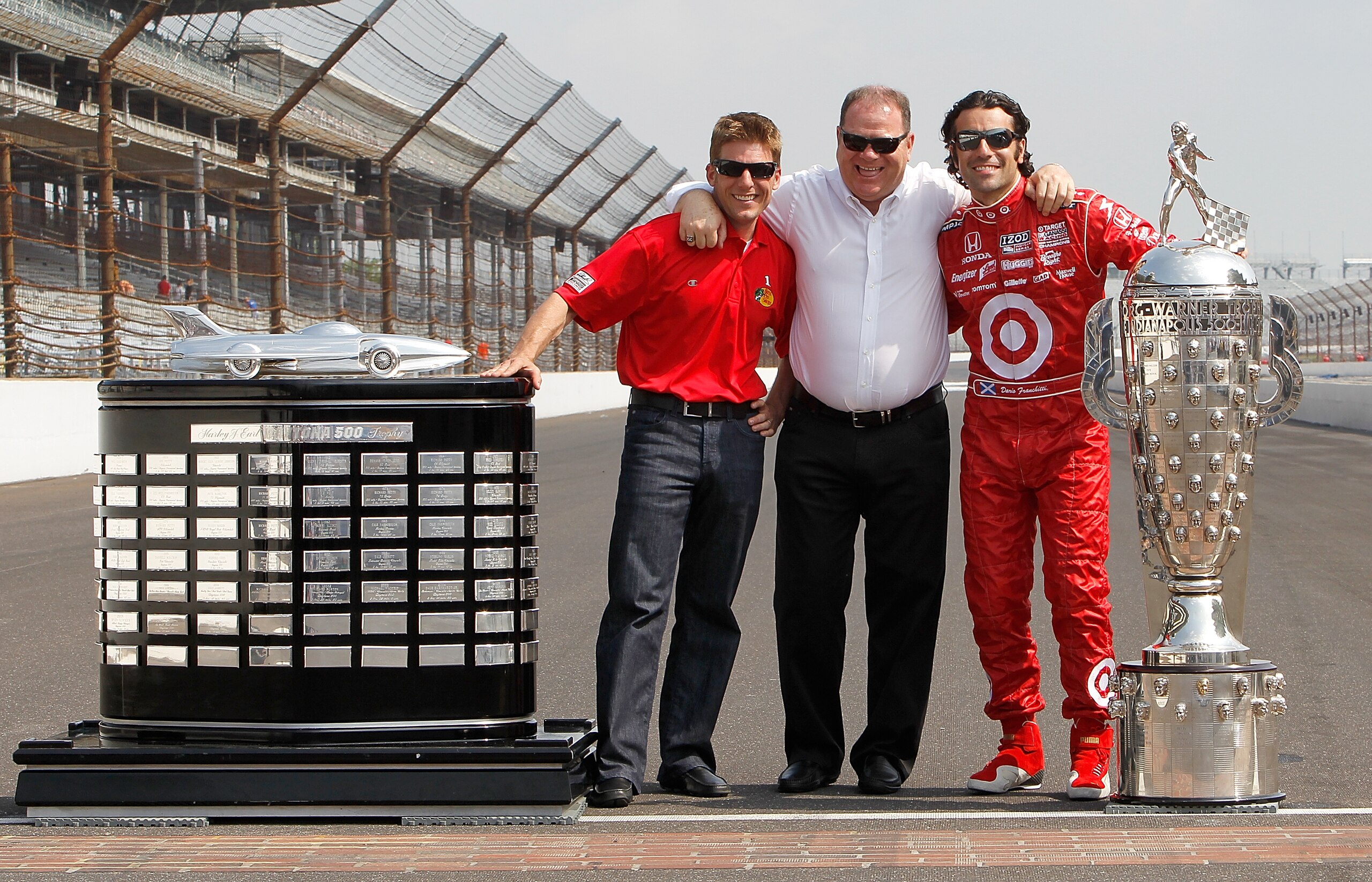 INDIANAPOLIS - MAY 31:  Dario Franchitti (R) of Scotland, driver of the #10 Target Chip Ganassi Racing Dallara Honda, with the Borg Warner Trophy poses with team owner Chip Ganassi (C) and Chip Ganassi Racing NASCAR driver and 2010 Daytona 500 winner Jami