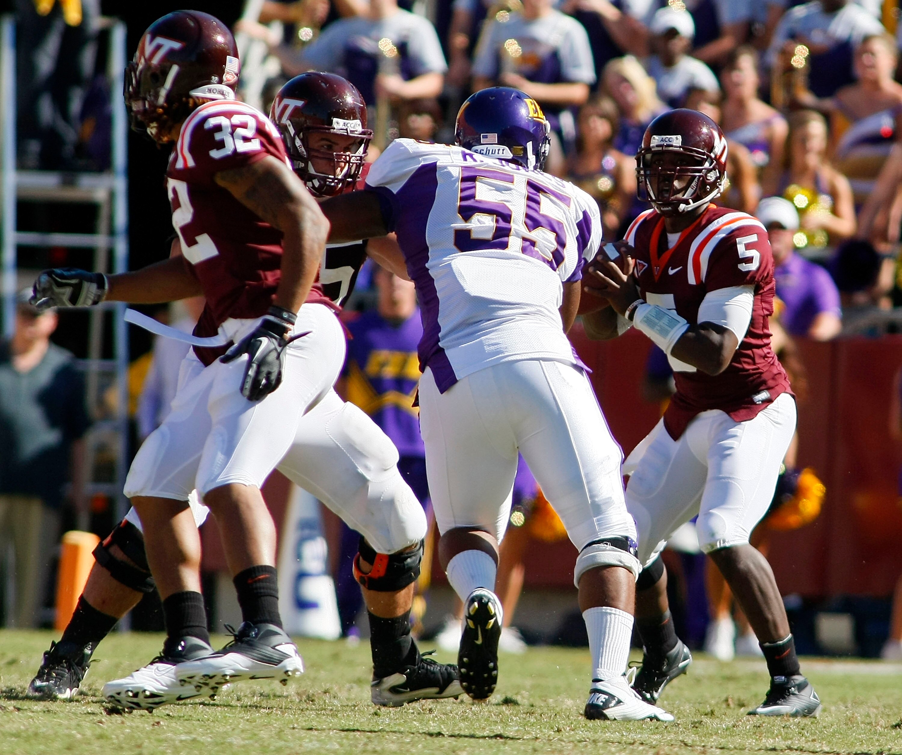 BLACKSBURG, VA - SEPTEMBER 18: Quarterback Tyrod Taylor #5 of the Virginia Tech Hokies looks to pass the ball as defensive tackle Robert Jones #55 of the East Carolina Pirates defends at Lane Stadium on September 18, 2010 in Blacksburg, Virginia.  (Photo