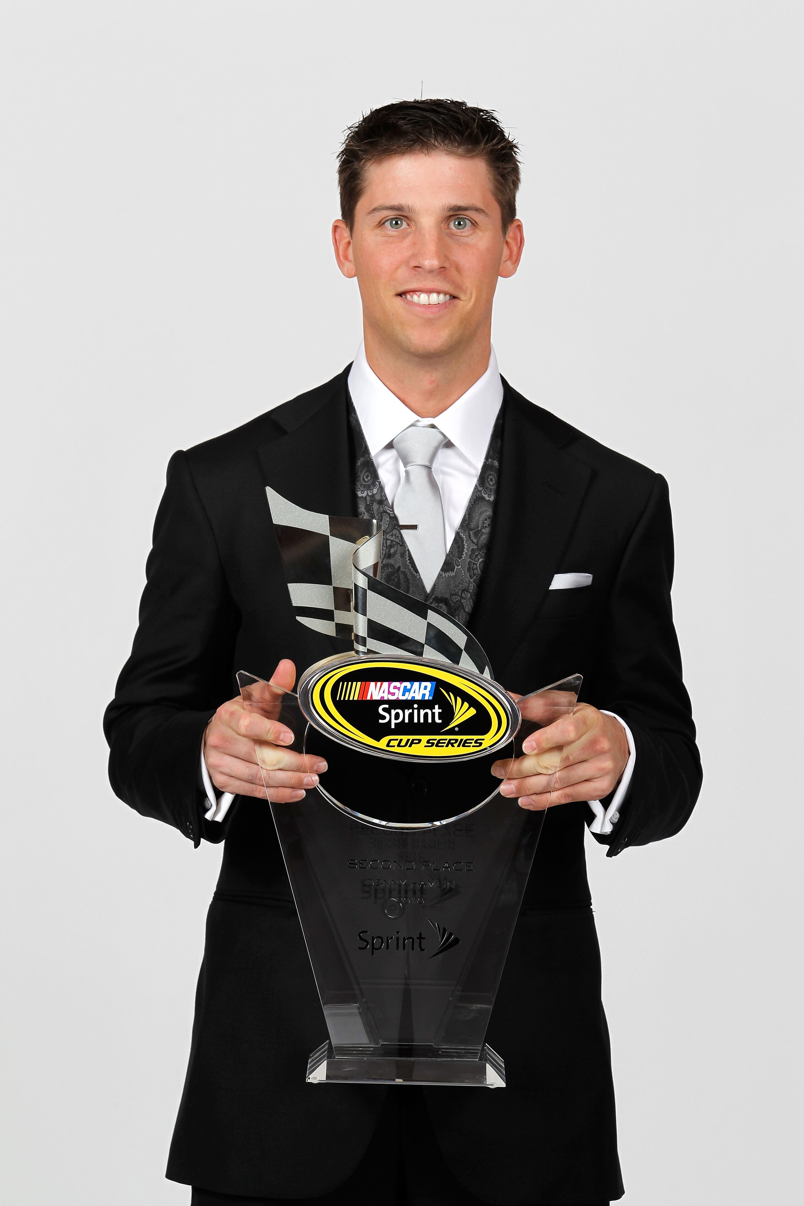 LAS VEGAS, NV - DECEMBER 03:  NASCAR driver Denny Hamlin poses with his second place trophy during the NASCAR Sprint Cup Series awards banquet at the Wynn Las Vegas Hotel on December 3, 2010 in Las Vegas, Nevada.  (Photo by Todd Warshaw/Getty Images for N