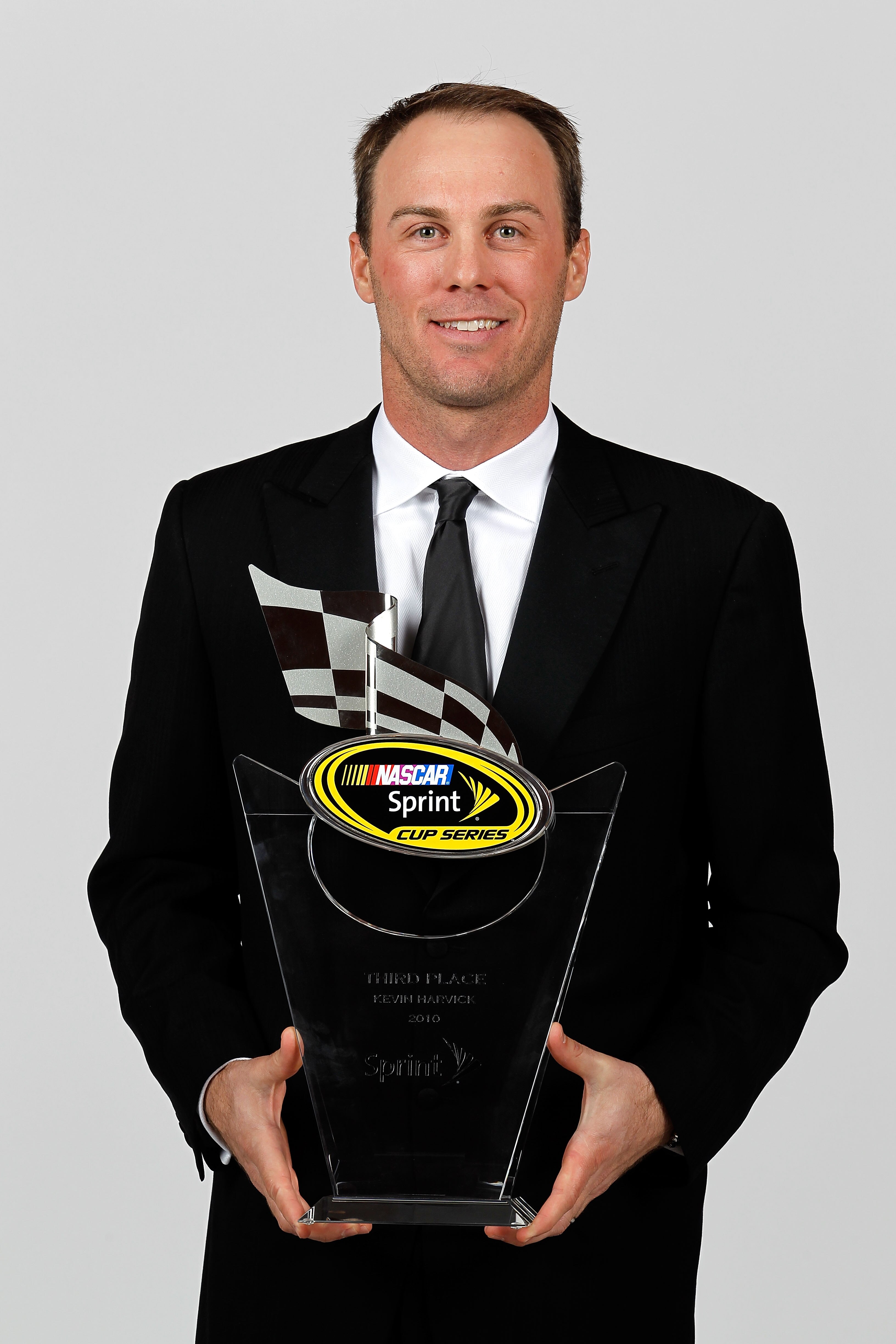 LAS VEGAS, NV - DECEMBER 03:  NASCAR driver Kevin Harvick poses with his third place trophy during the NASCAR Sprint Cup Series awards banquet at the Wynn Las Vegas Hotel on December 3, 2010 in Las Vegas, Nevada.  (Photo by Todd Warshaw/Getty Images for N