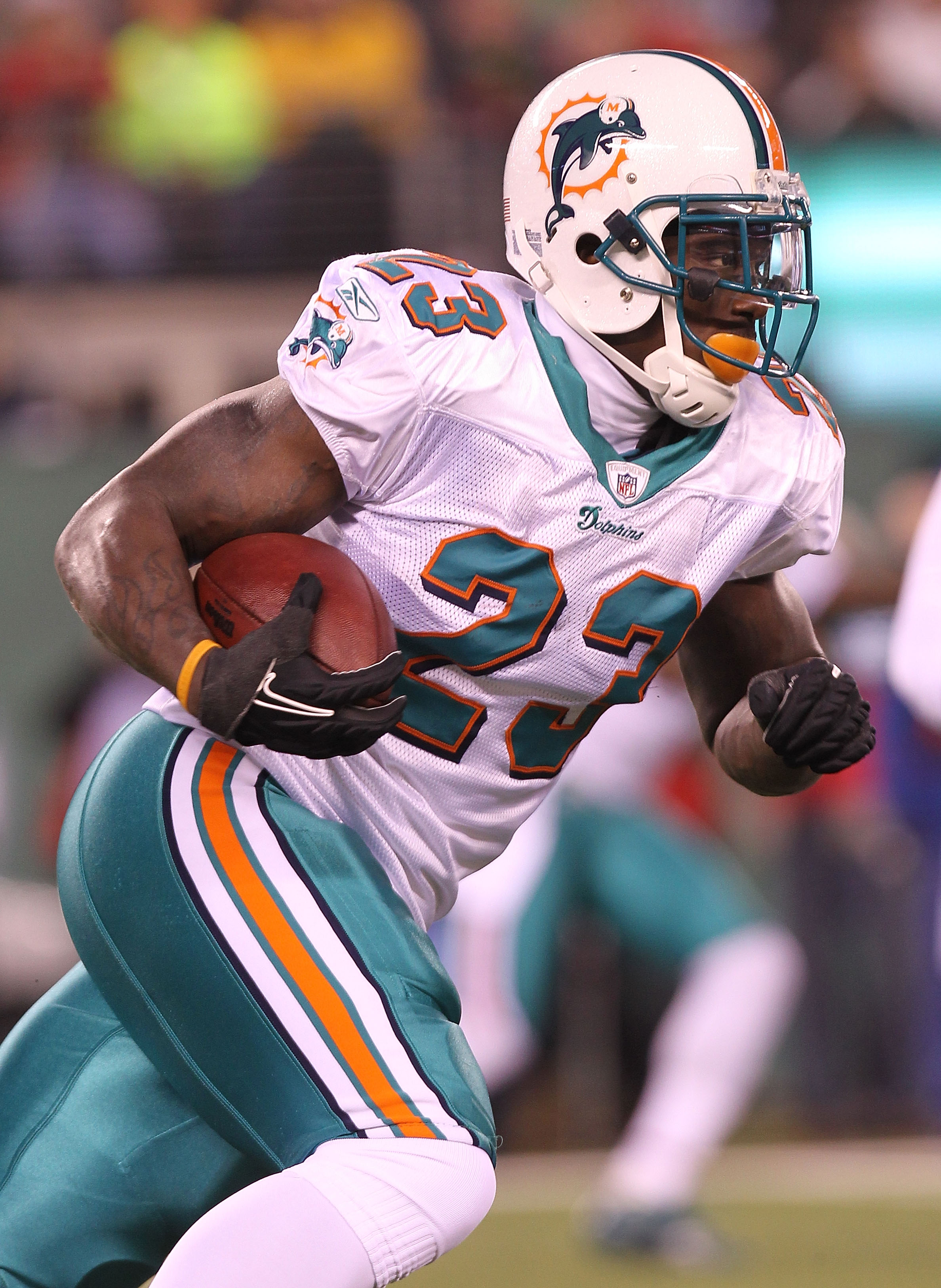 EAST RUTHERFORD, NJ - DECEMBER 12:  Ronnie Brown #23 of the Miami Dolphins rushes against the New York Jets at New Meadowlands Stadium on December 12, 2010 in East Rutherford, New Jersey.  (Photo by Nick Laham/Getty Images)
