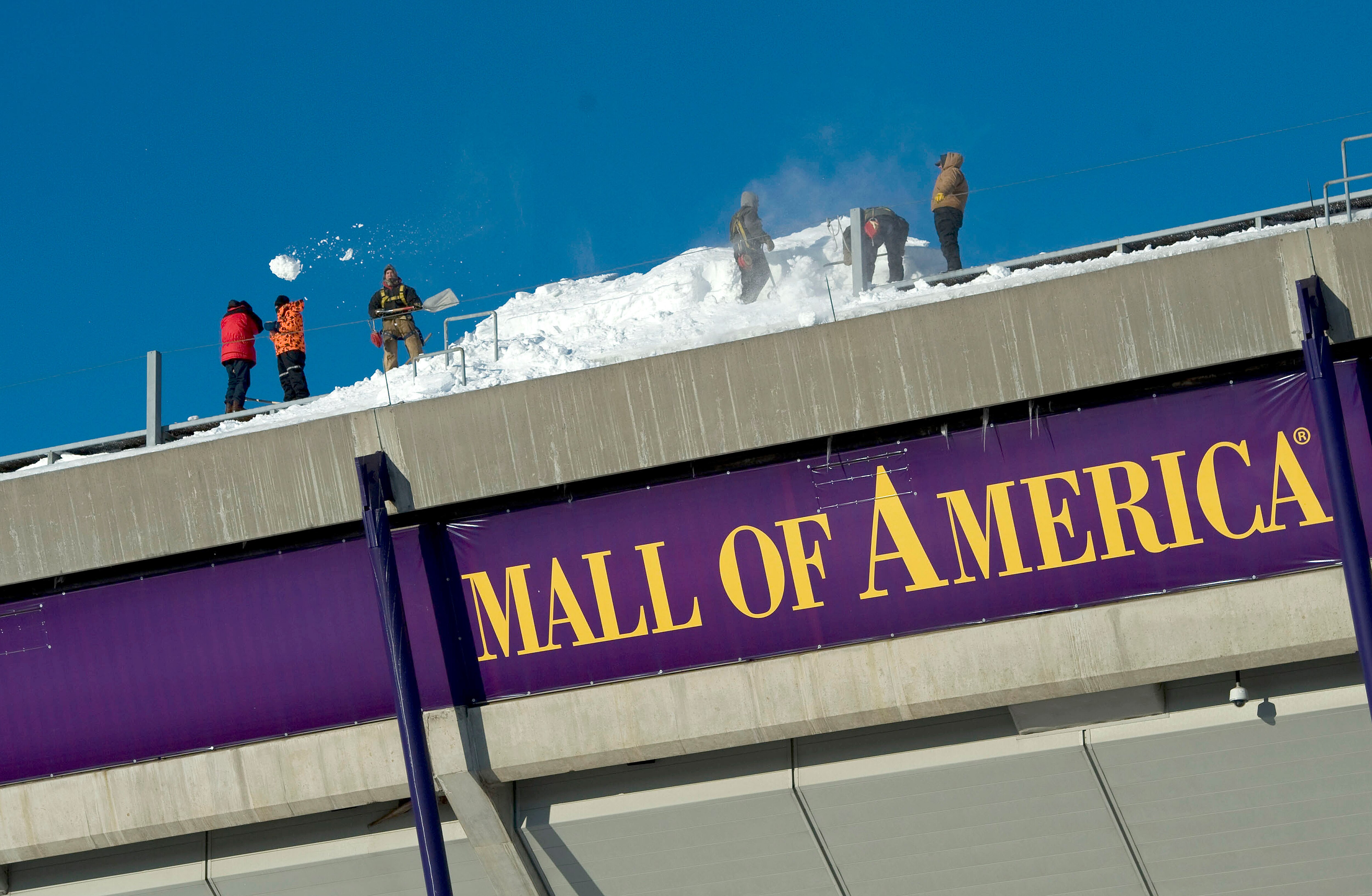 MINNEAPOLIS, MN - DECEMBER 12:  Workers shovel snow off of the Hubert H. Humphrey Metrodome, Mall of America Stadium where the inflatable roof collapsed under the weight of snow during a storm Sunday morning December 12, 2010 in Minneapolis, Minnesota. A
